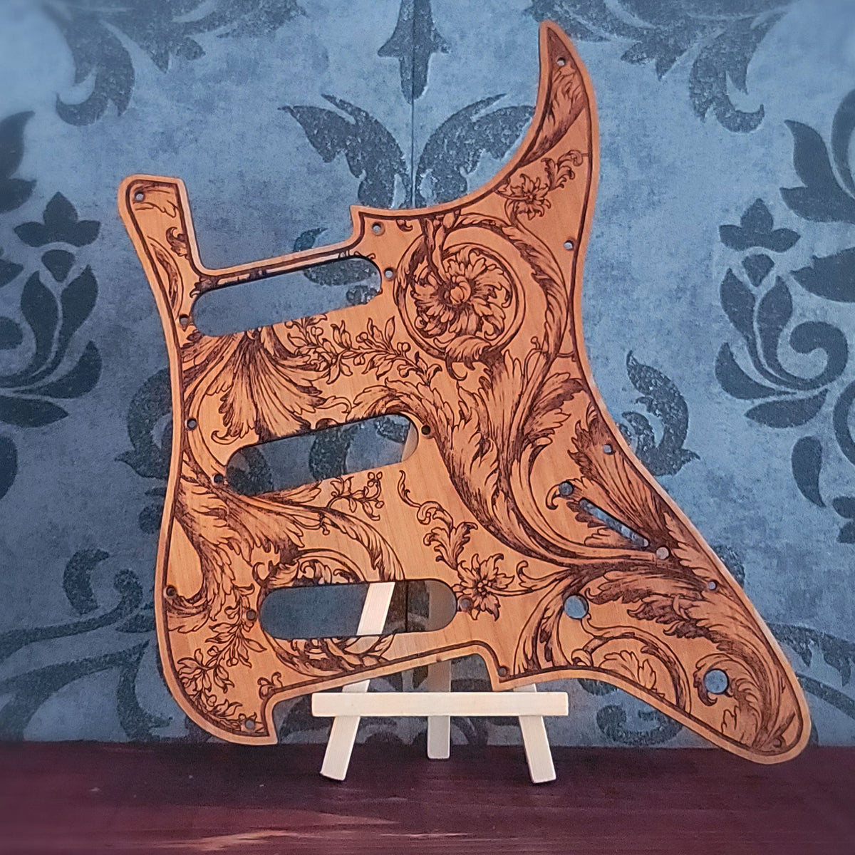 Full display view of Floral I acanthus artwork cherrywood Stratocaster pickguard; available with custom pickup and bridge routing