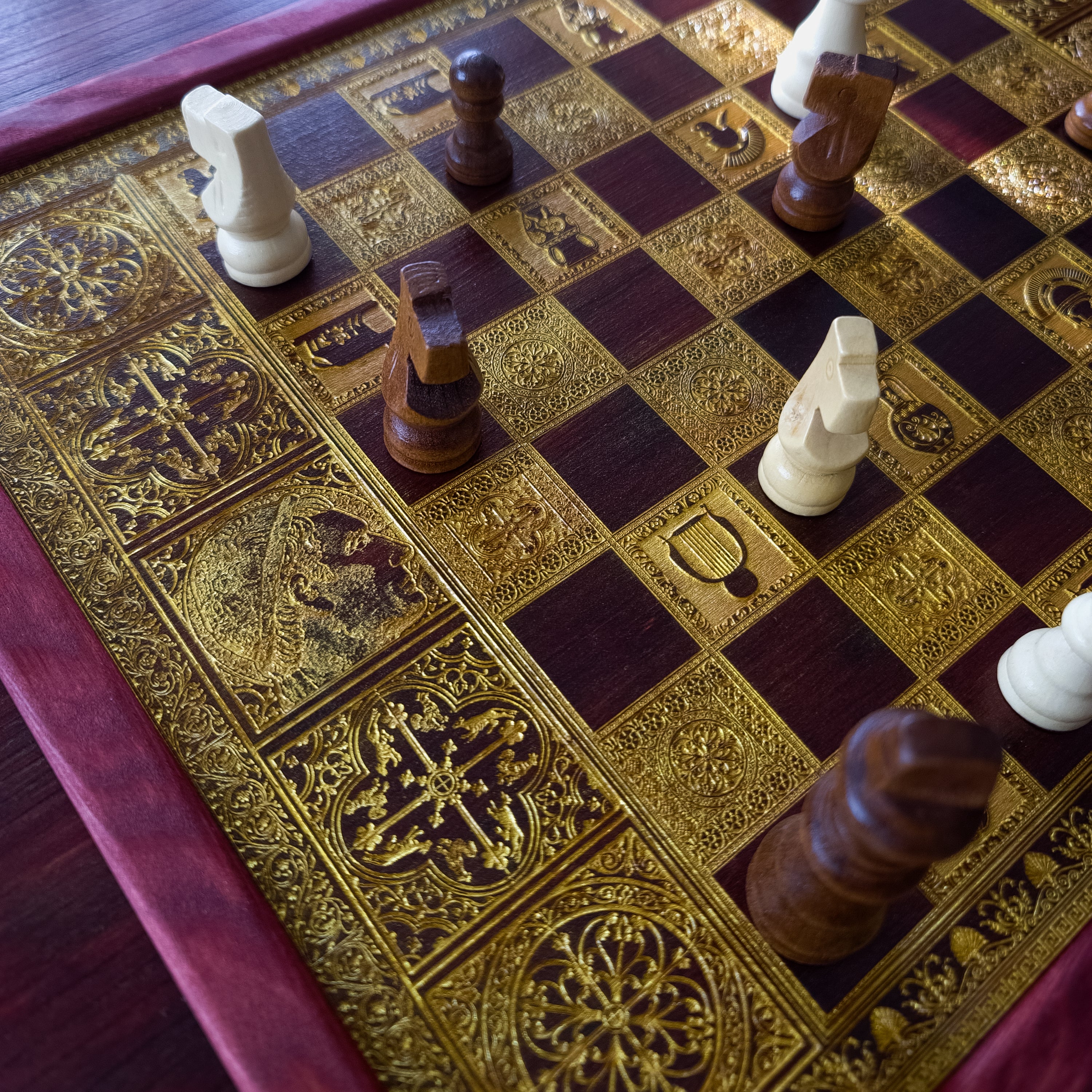 Handmade wooden chessboard coffee table with Roman laser engraving, pine and maple wood, gold details, red walnut finish.