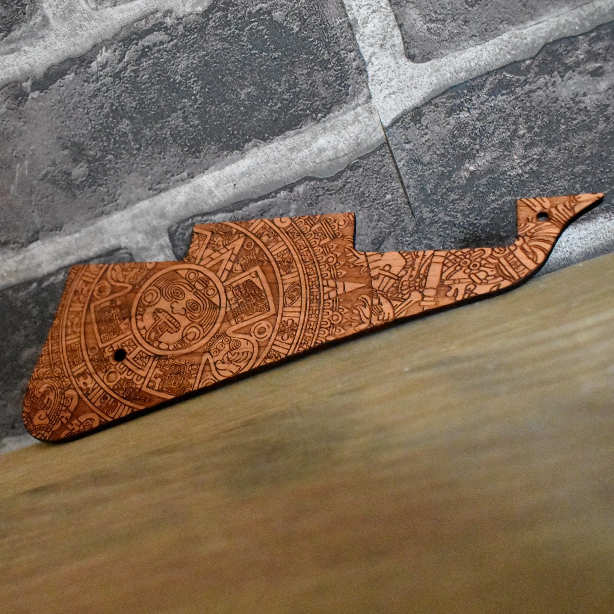 Custom cherrywood Les Paul pickguard with intricate Aztec engraving.