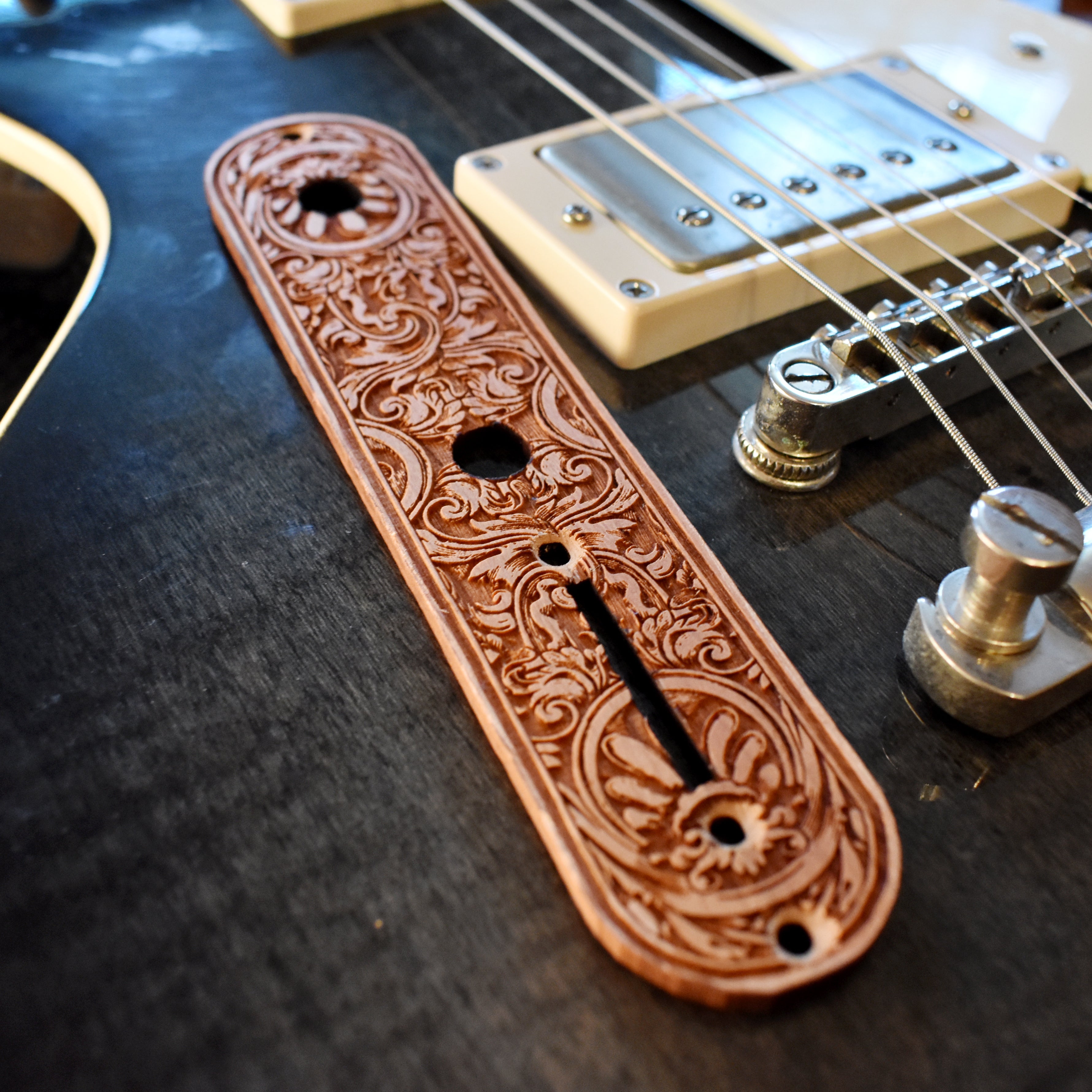 Laserβengraved floral wood control plate replacement for Telecaster guitar in warm brown finish