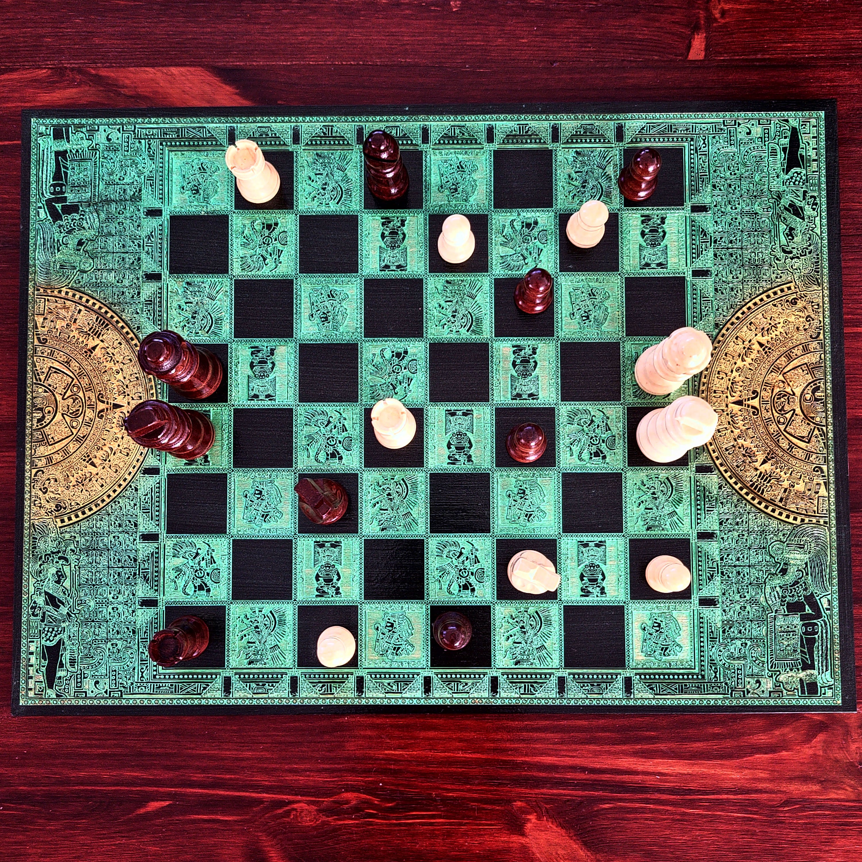 green and black wood chessboard laser engraved with mayan symbols and aztec calendar