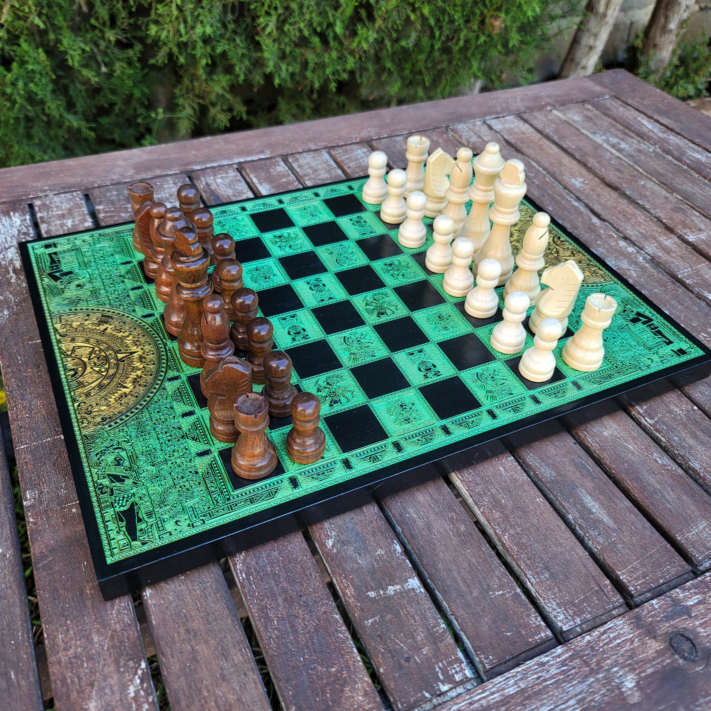 Close-up of premium laser-engraved Aztec artwork on wooden chessboard