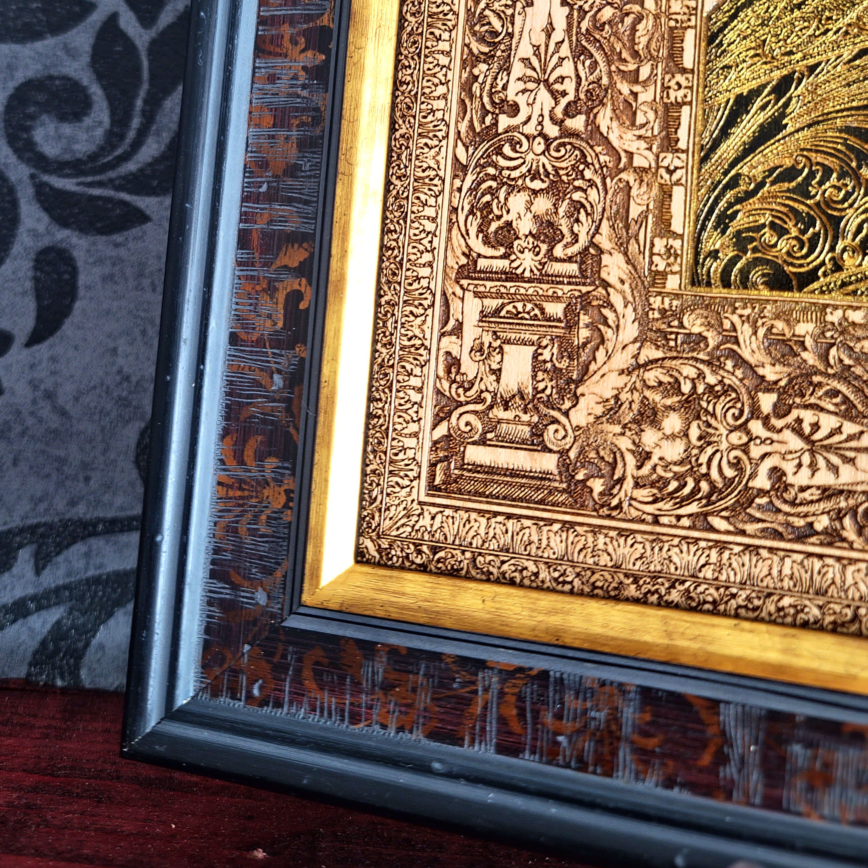 Black-and-gold medieval knight helmet maple wood wall art, close-up of the gold frame and engraved corner