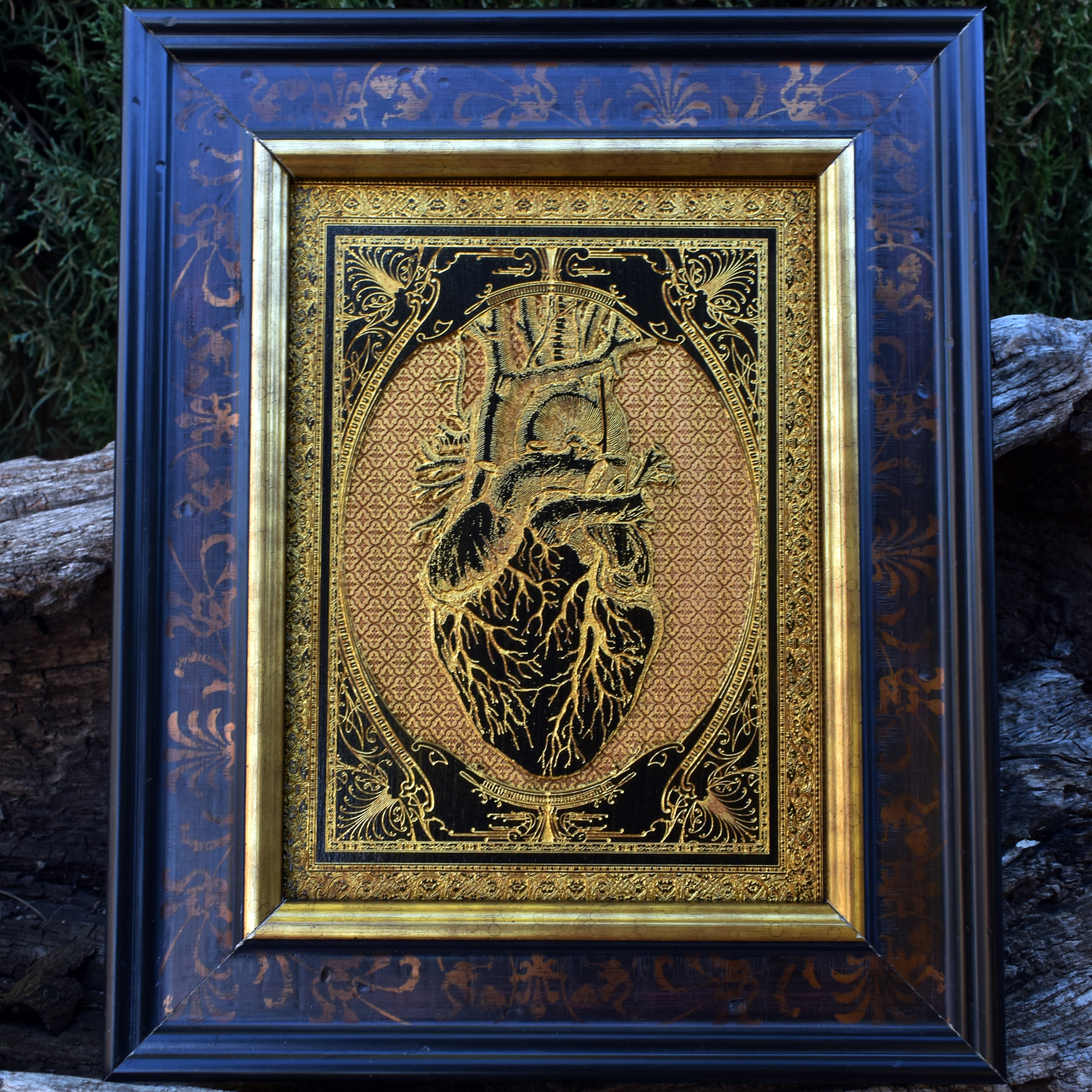 Wooden anatomical heart artwork, black-painted with gold filling, perfect for gothic decor.