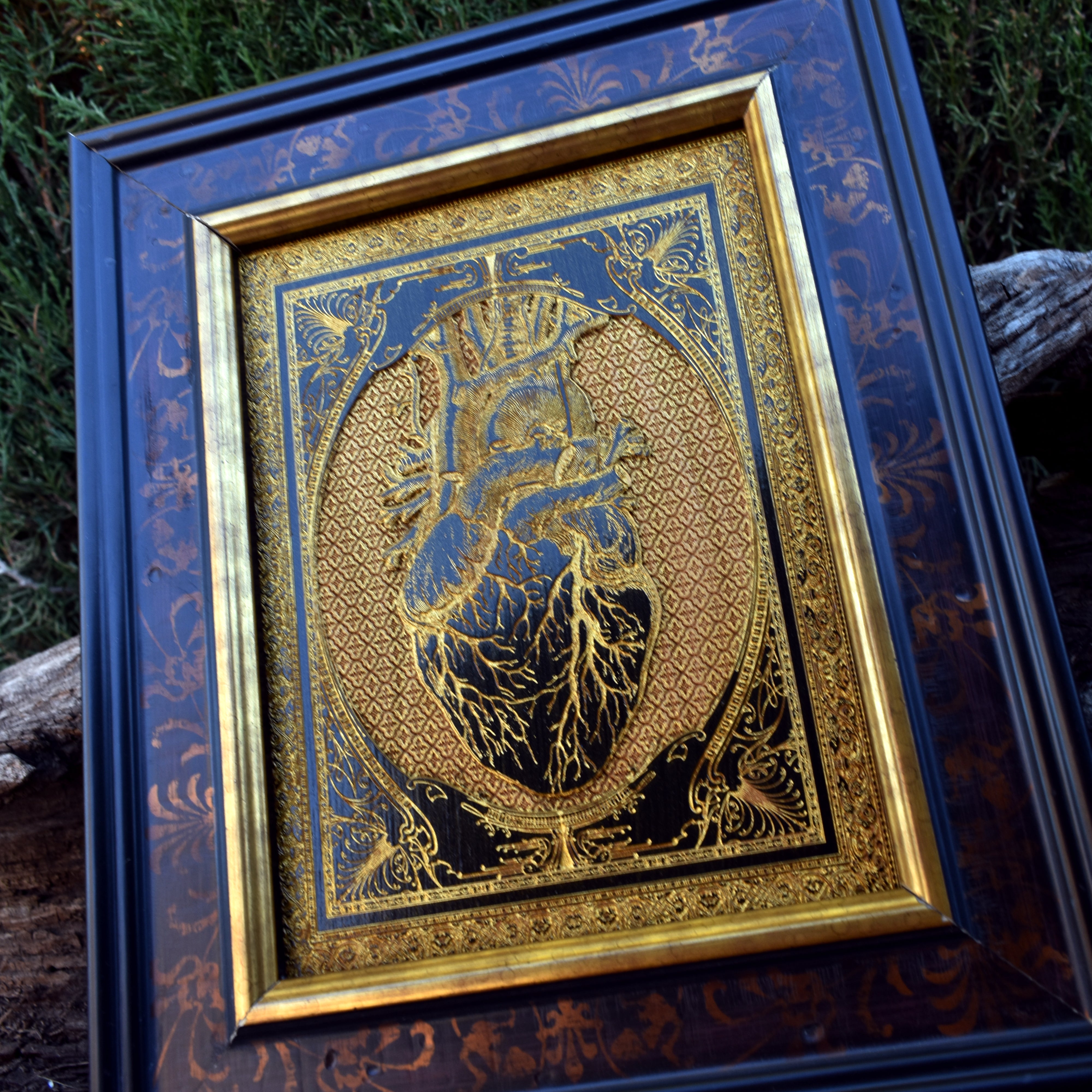 Gothic anatomical heart art, black and gold design on wood, ideal for dark art lovers.