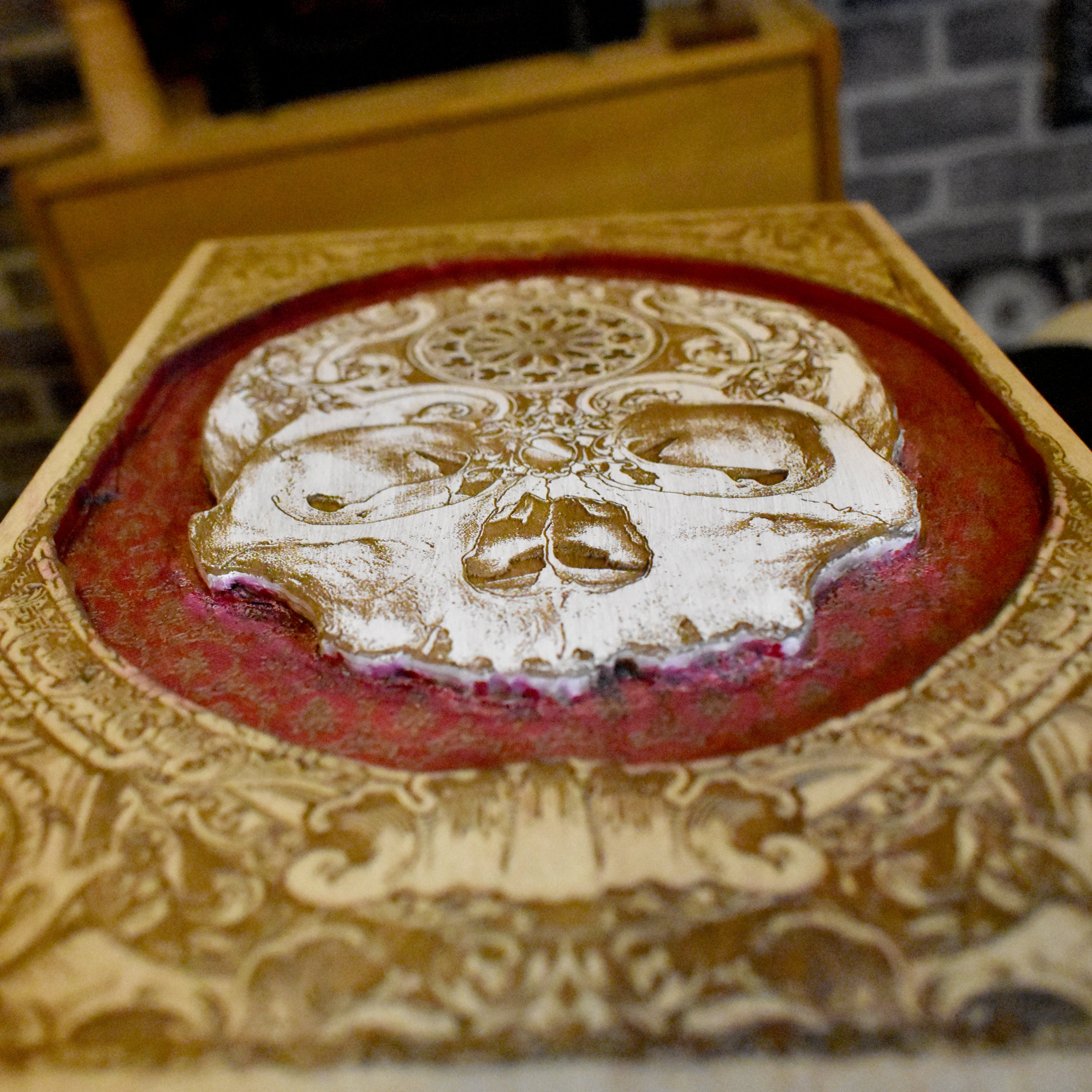 Detailed skull carving on wooden panel
