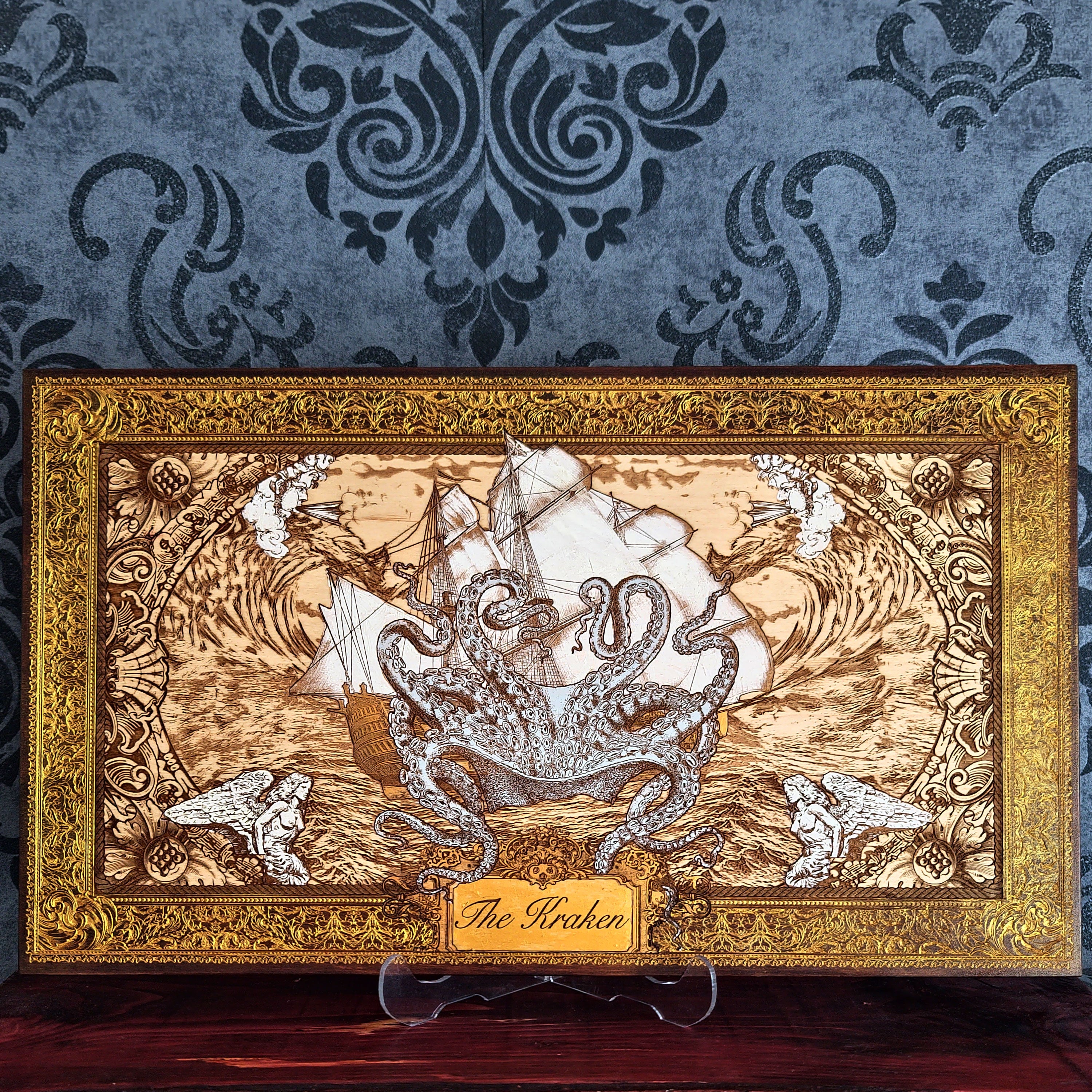 Kraken engraved wood wall art with giant octopus attacking sailing ship, ocean waves and hand painted ornate gold nautical frame