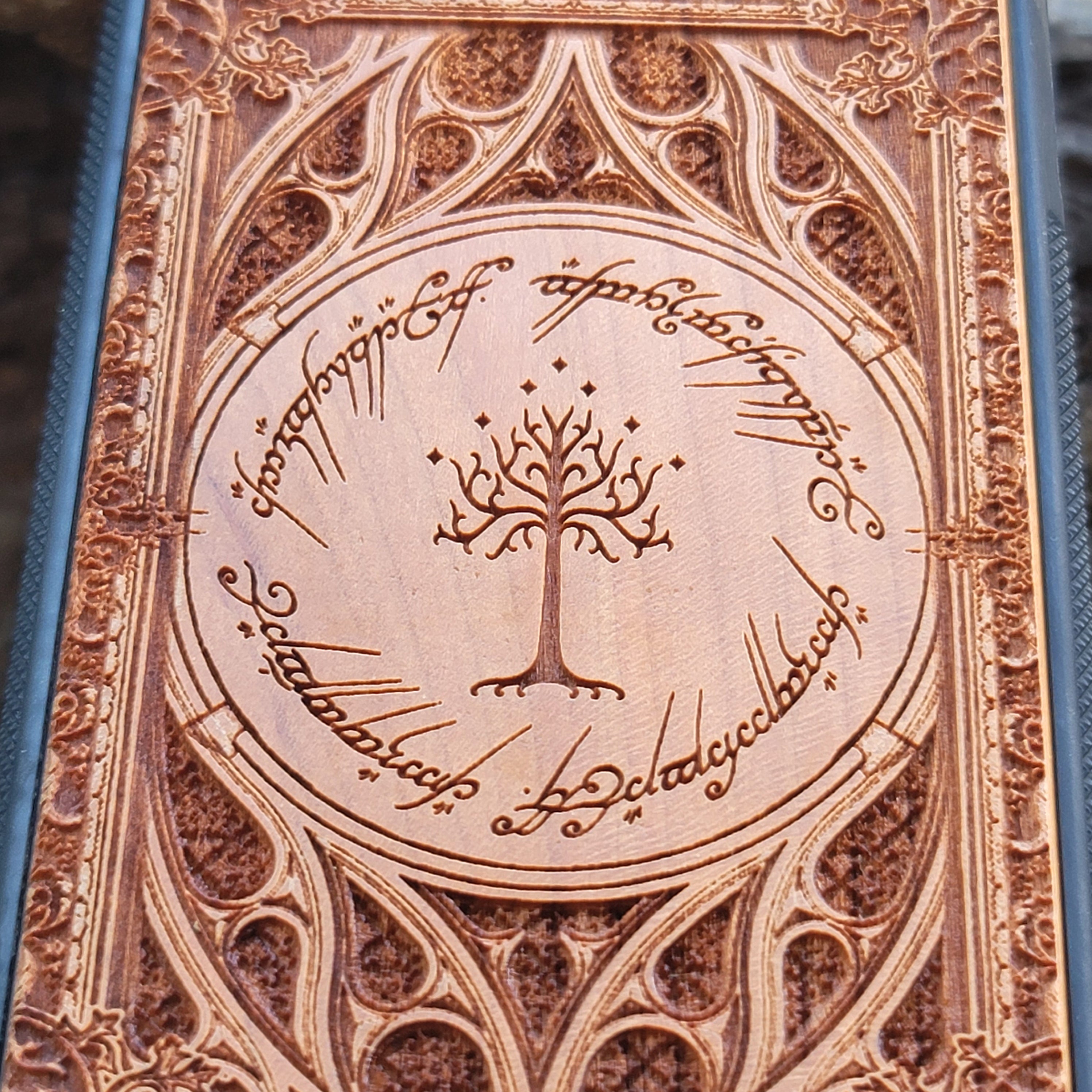 Gothic design wood phone case featuring intricate laser-engraved patterns inspired by Lord of the Rings. Compatible with iPhone , iPhone 15, 14, 13, 12, 11 Pro Max Mini, and Samsung Galaxy S, S24, S23, S22, S21, S20 Ultra, Plus, Note 20. Durable, slim, and stylish for Tolkien fans.