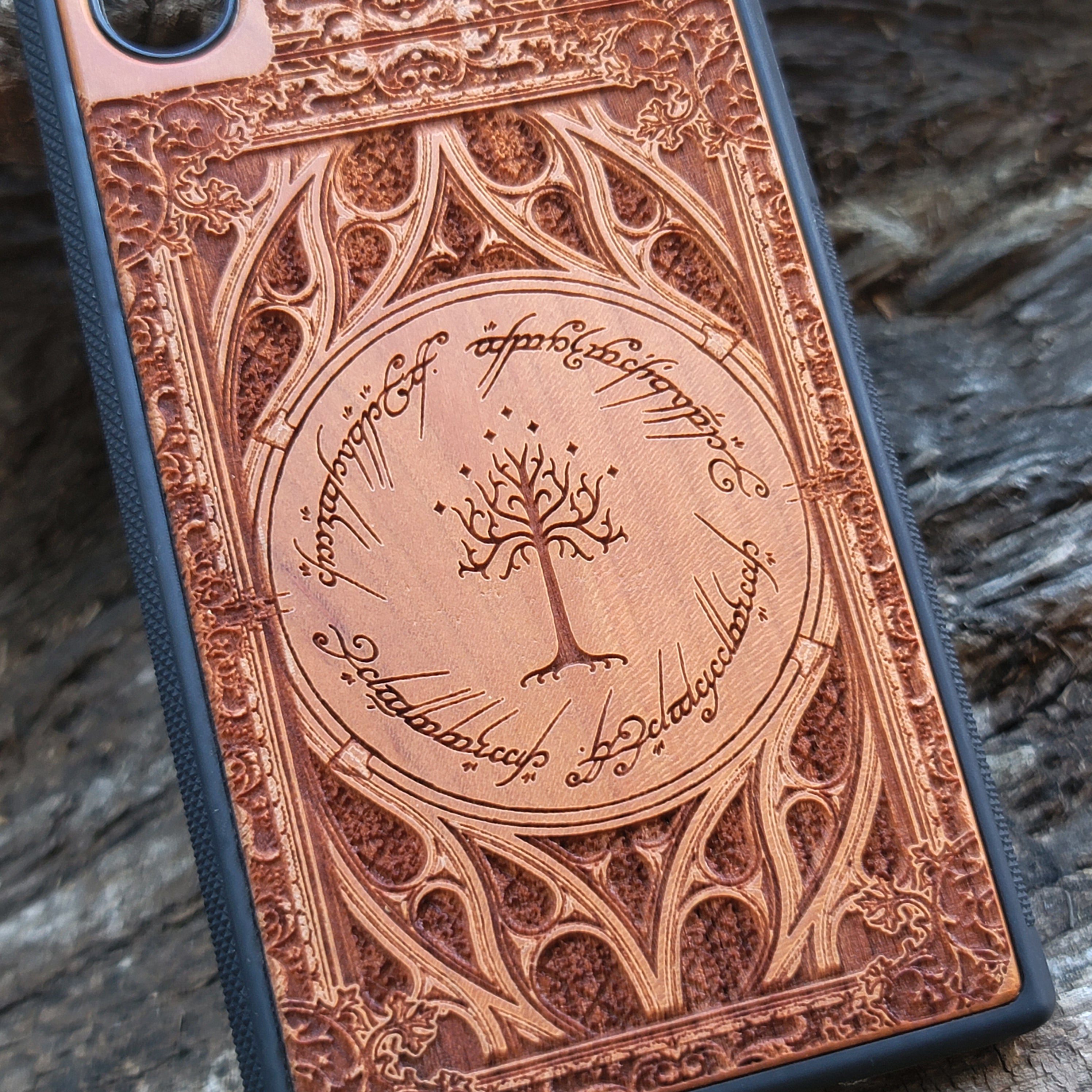 Gothic design wood phone case featuring intricate laser-engraved patterns inspired by Lord of the Rings. Compatible with iPhone , iPhone 15, 14, 13, 12, 11 Pro Max Mini, and Samsung Galaxy S, S24, S23, S22, S21, S20 Ultra, Plus, Note 20. Durable, slim, and stylish for Tolkien fans.