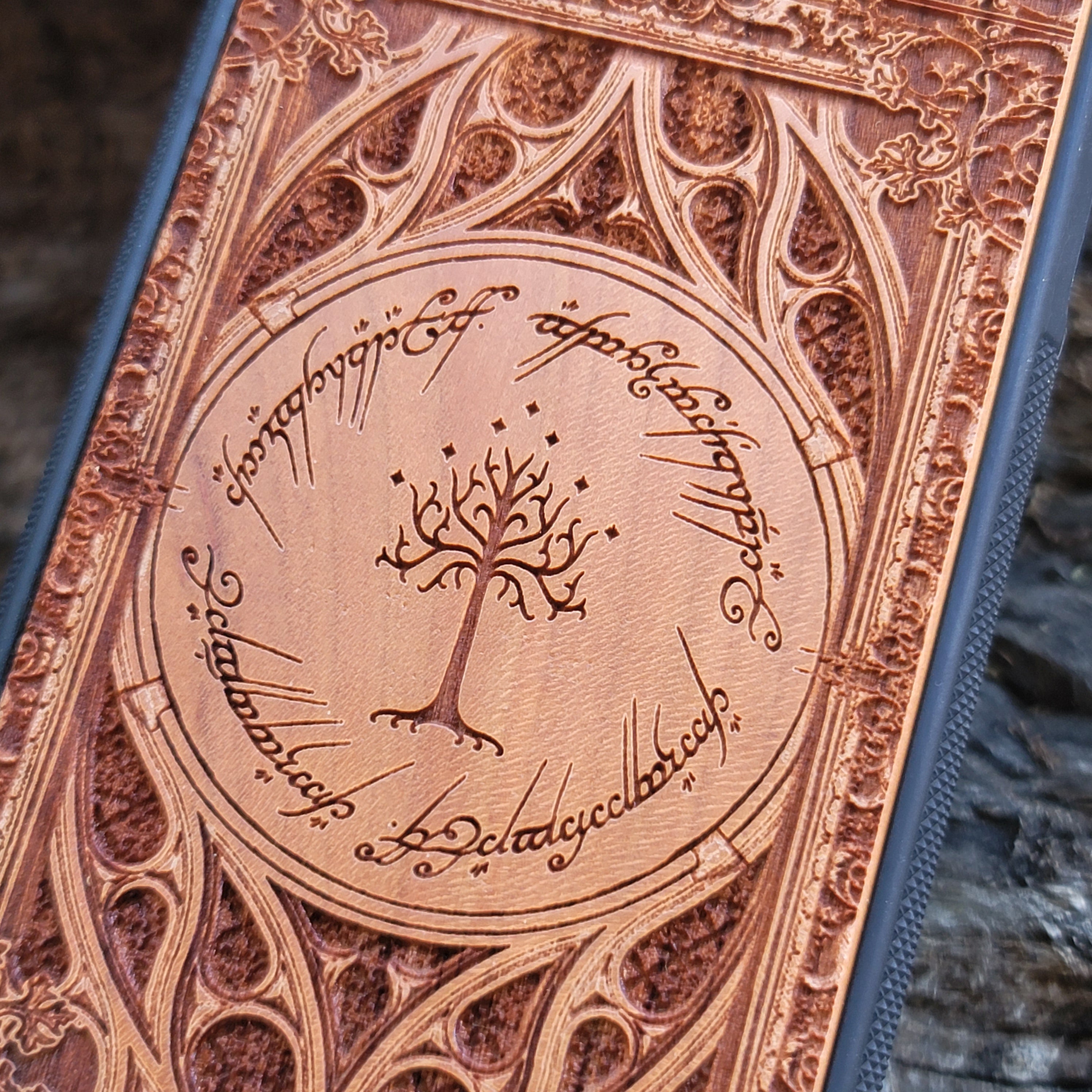 Gothic design wood phone case featuring intricate laser-engraved patterns inspired by Lord of the Rings. Compatible with iPhone , iPhone 15, 14, 13, 12, 11 Pro Max Mini, and Samsung Galaxy S, S24, S23, S22, S21, S20 Ultra, Plus, Note 20. Durable, slim, and stylish for Tolkien fans.