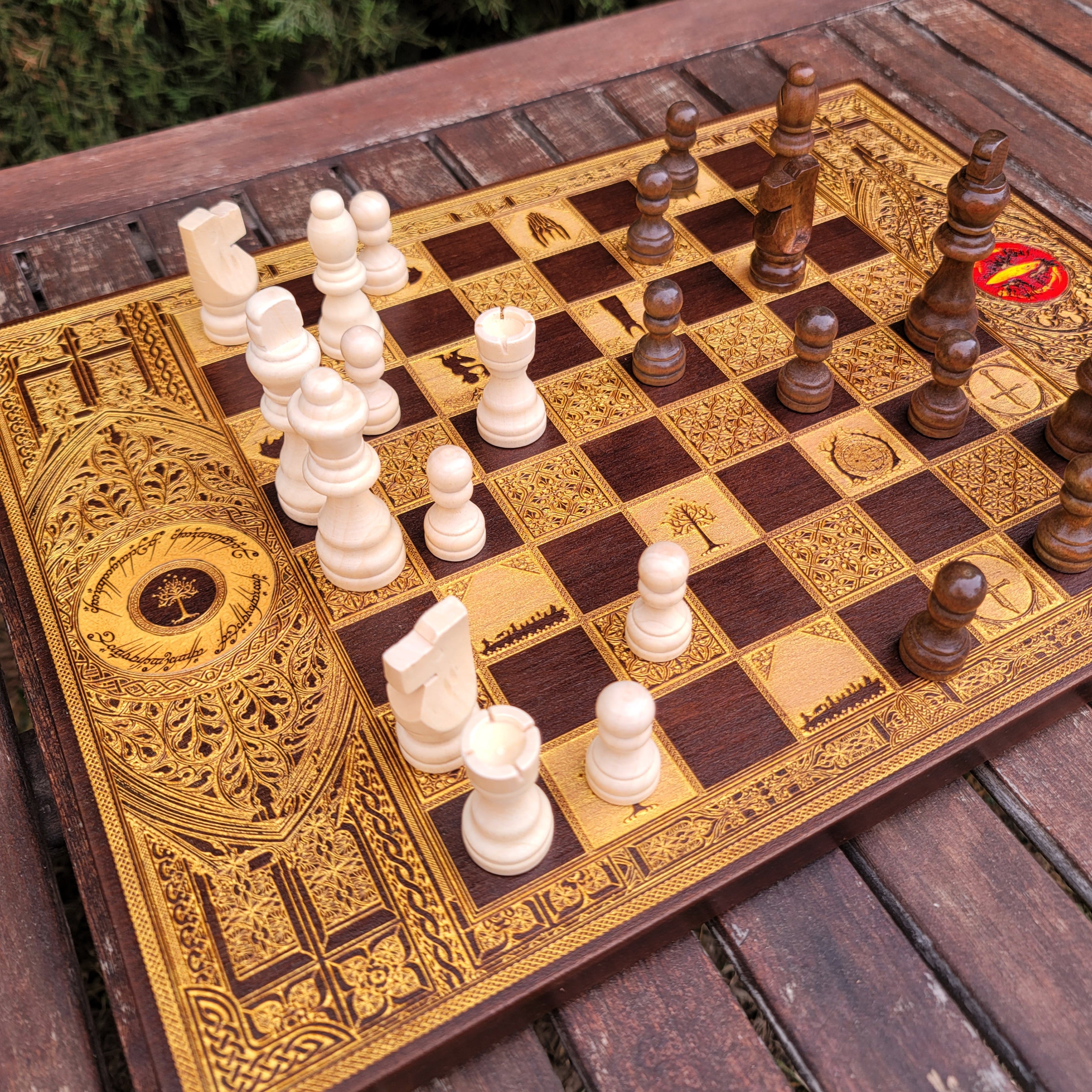 Luxury wooden chess set featuring laser-engraved Tolkien-inspired gold artwork on walnut wood.