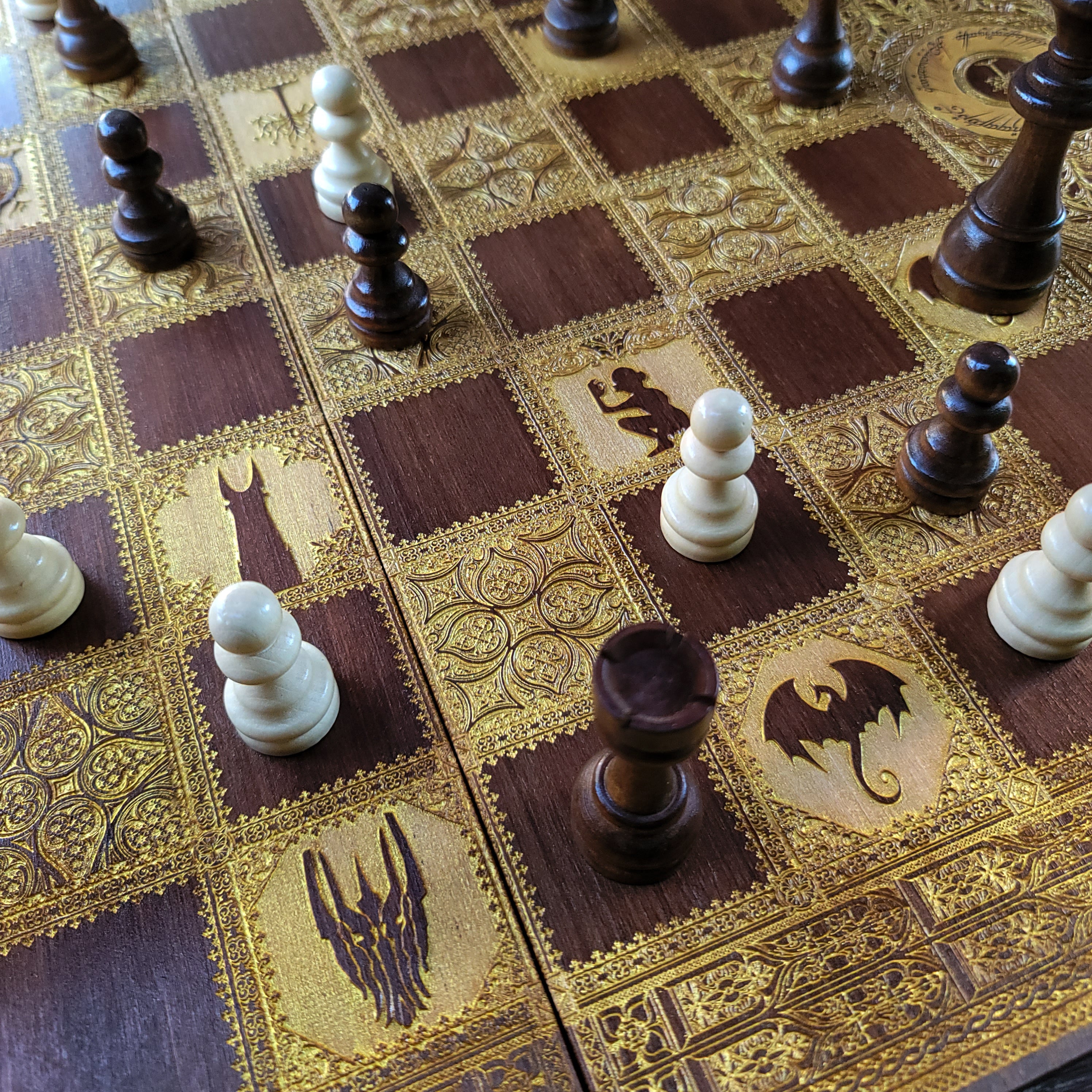 Ornate stained wood chess board with laser-engraved fantasy design.