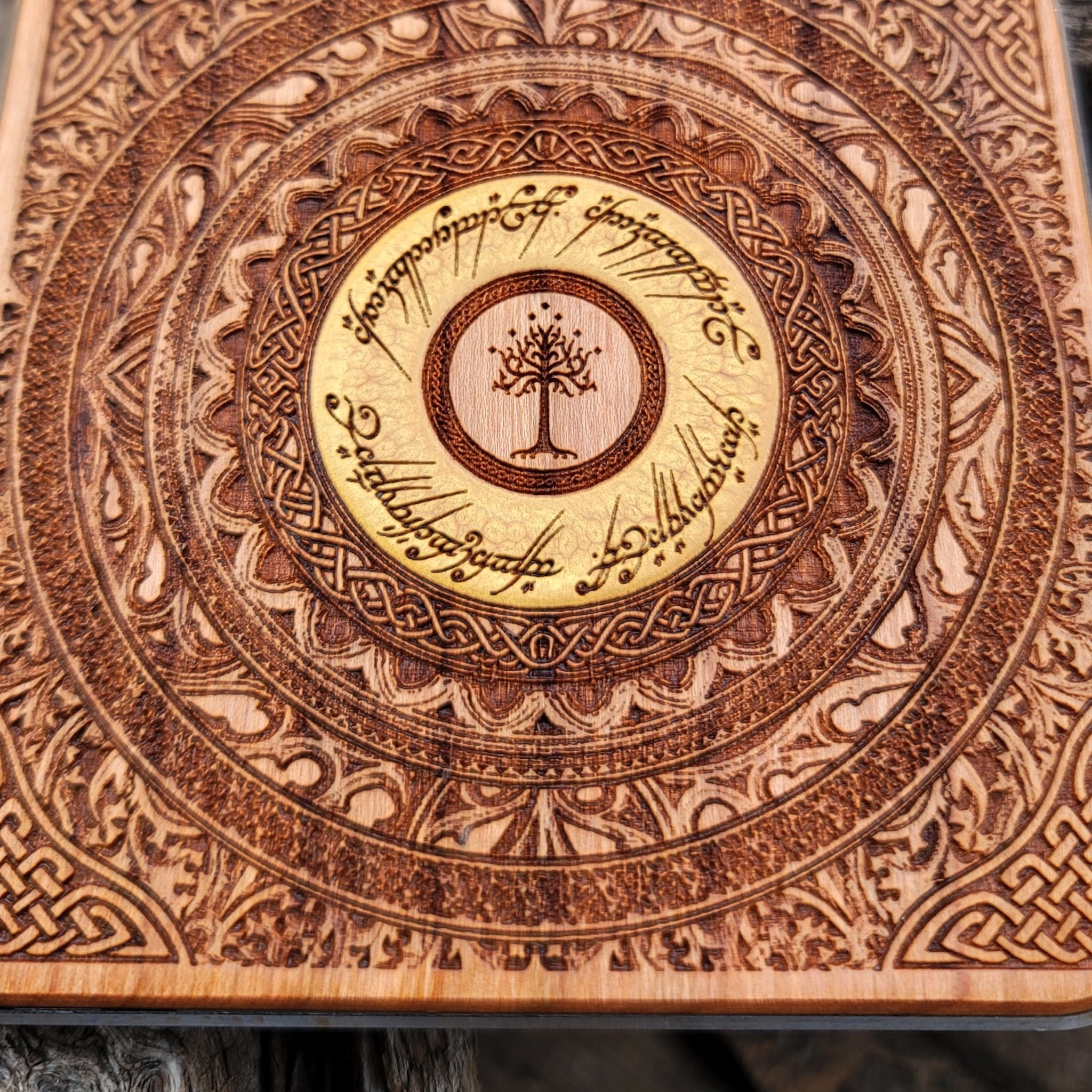 Close-up of elven script from Middle-earth on wooden charger.