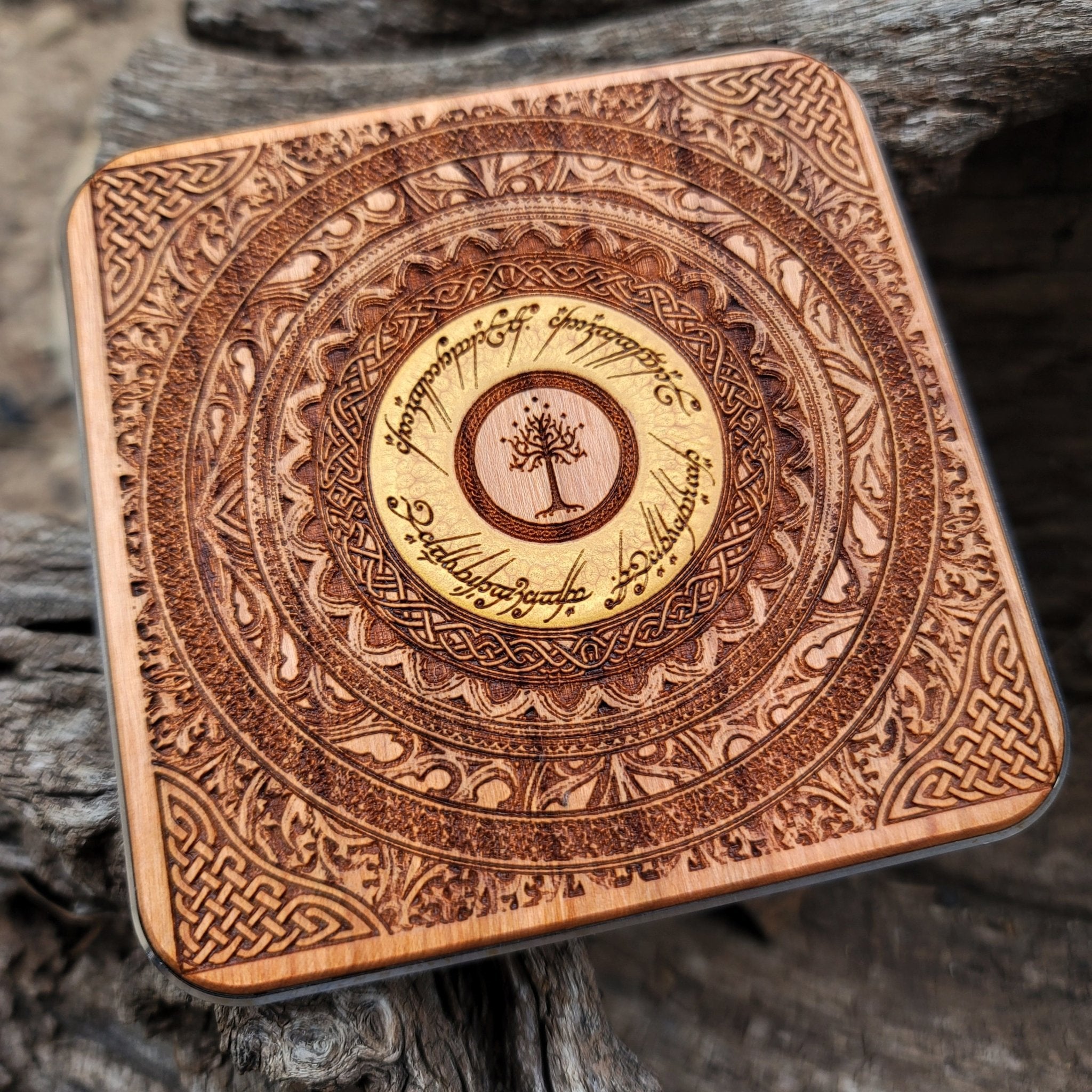 Overhead view of ancient Tolkien symbols hand-painted on charger.