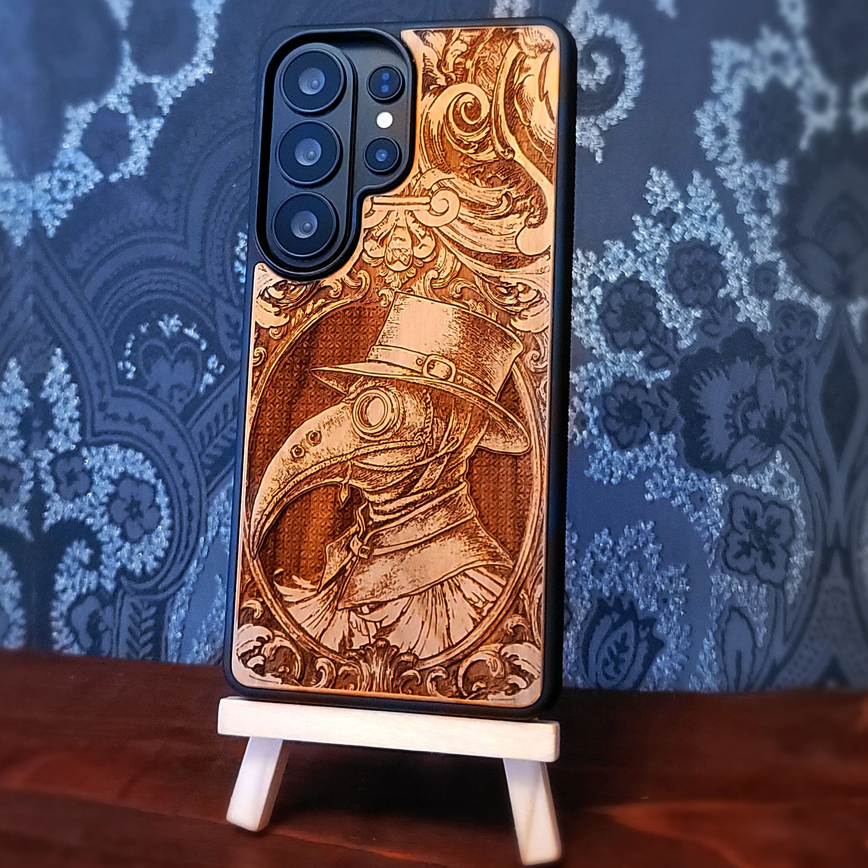 Deep laser engraved wooden phone case featuring a gothic Plague Doctor design on natural wood for iPhone and Samsung Galaxy.
