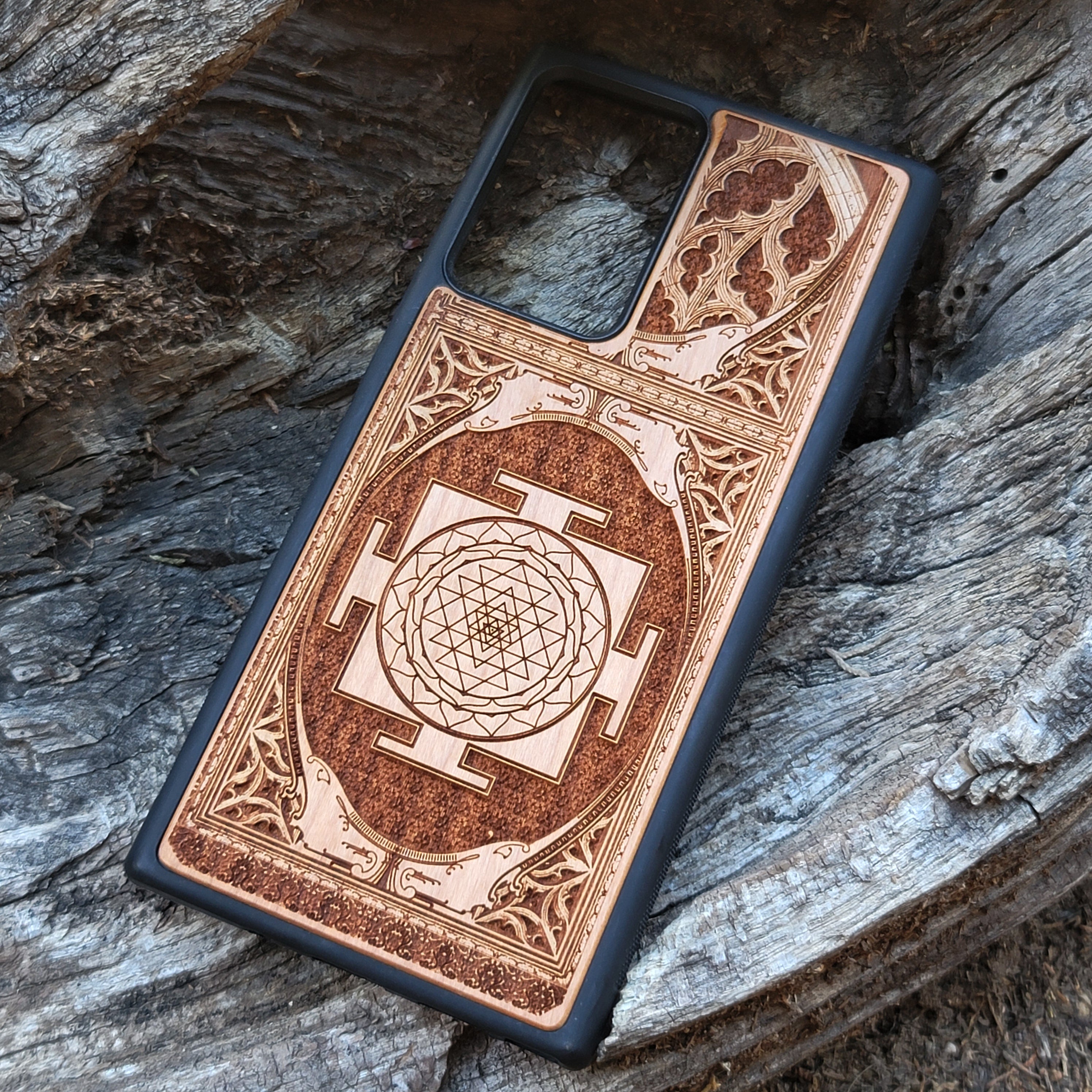 Wood phone case for iPhone & Samsung Galaxy featuring intricate Sri Yantra Chakra design. Laser-engraved with Gothic patterns, offering a unique, spiritual aesthetic. Slim, durable, and compatible with iPhone 15, 14, 13, 12, 11 Pro Max Mini & Samsung Galaxy S24, S23, S22, S21, S20 Ultra Plus Note 20. Stylish, protective, and personalized—order now!
