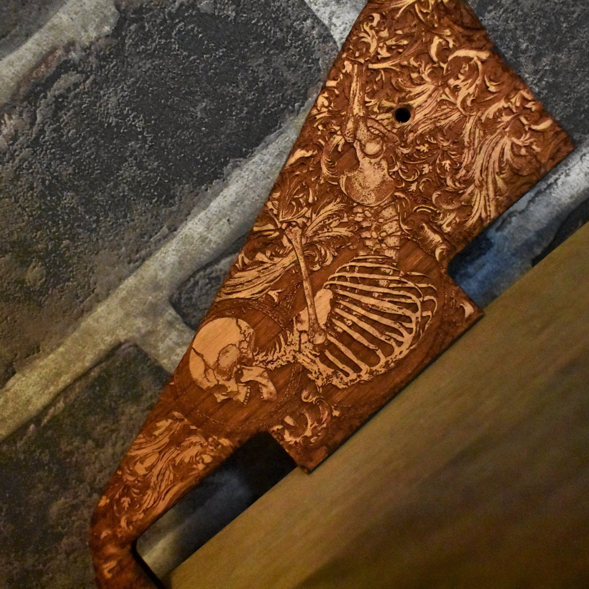 Hand-finished Gibson Les Paul pickguard showcasing intricate wood engraving.