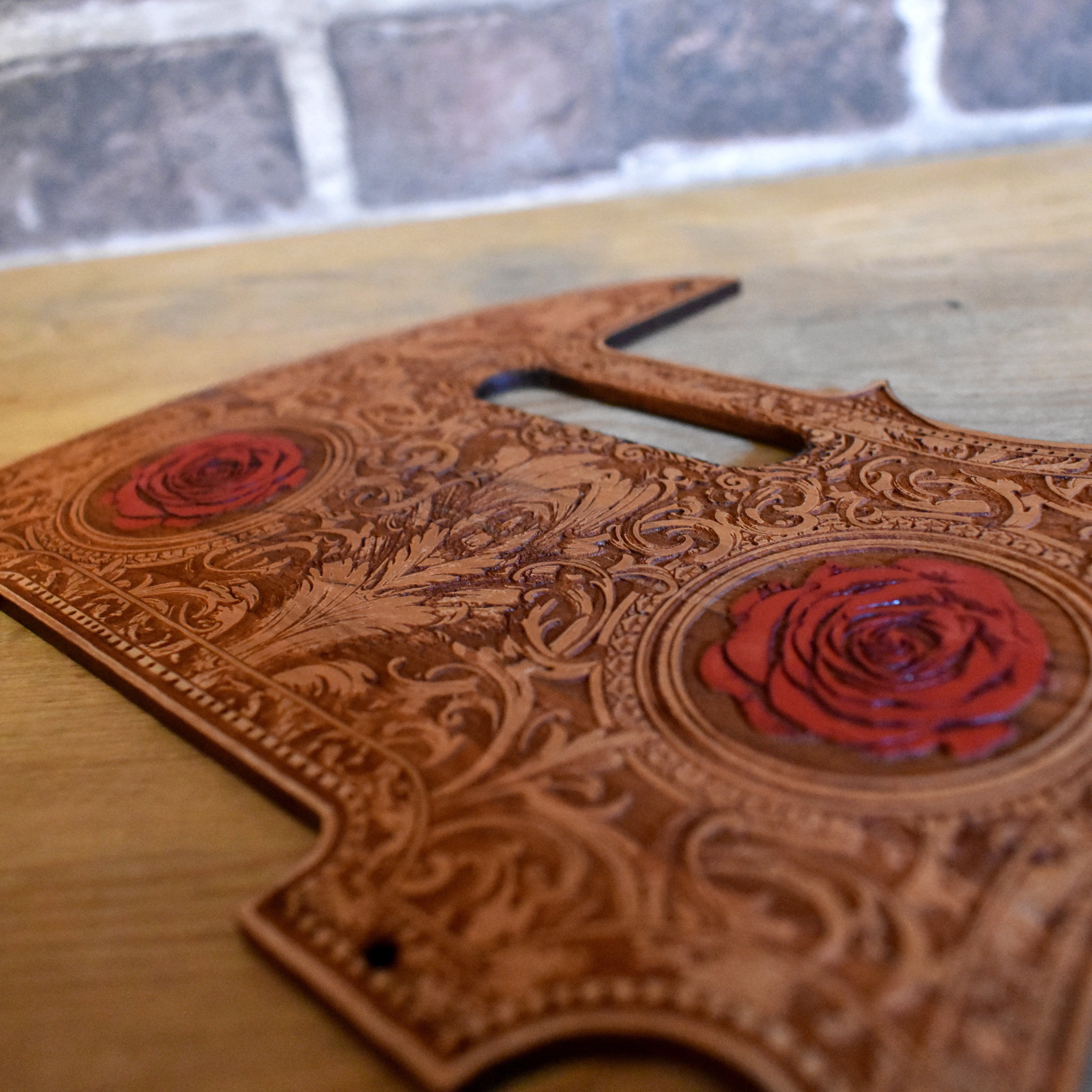 Fender Telecaster equipped with cherry wood pickguard featuring hand-painted roses artwork