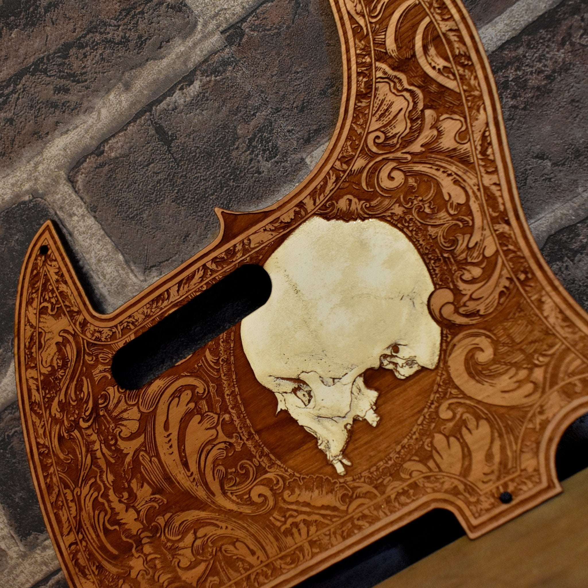 Close-up of skull engraving on cherry wood Fender Telecaster pickguard