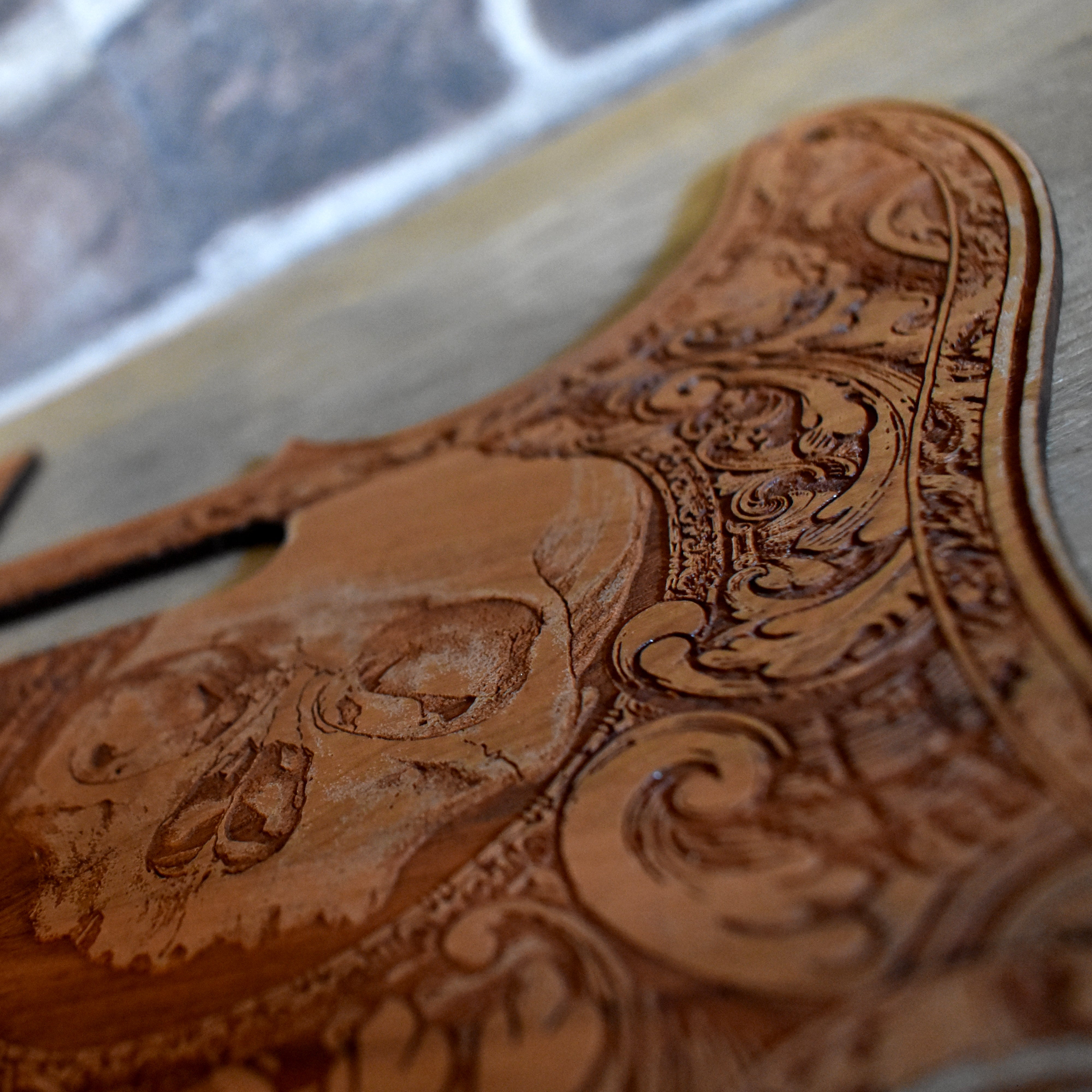 Close-up of detailed laser-engraved wood pickguard for Fender Telecaster