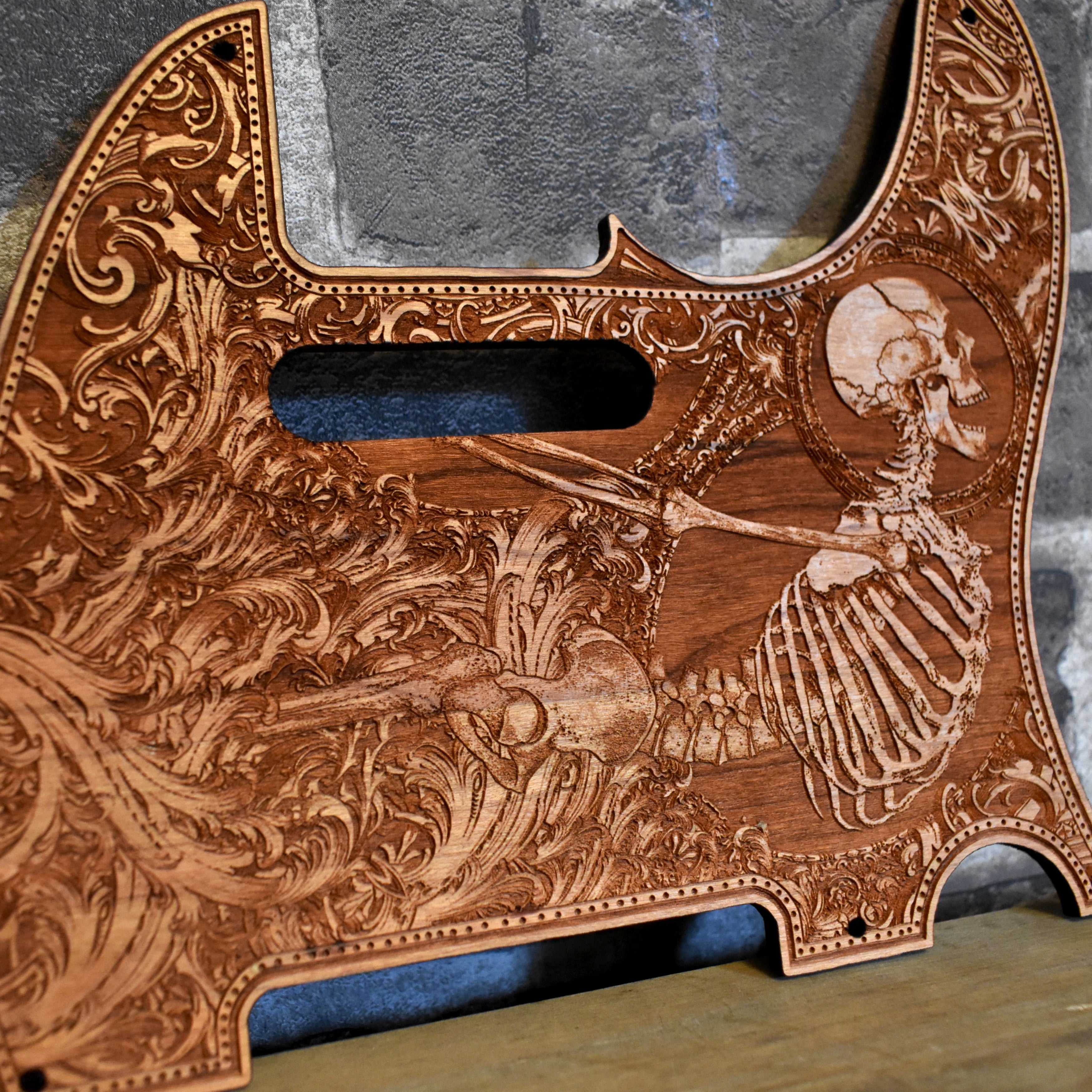 Close-up of hand-finished cherry wood pickguard for Fender Telecaster.