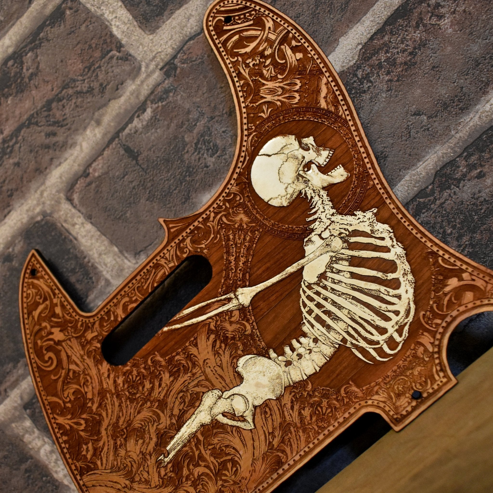Close-up of skull engraving on cherry wood pickguard for Fender Telecaster