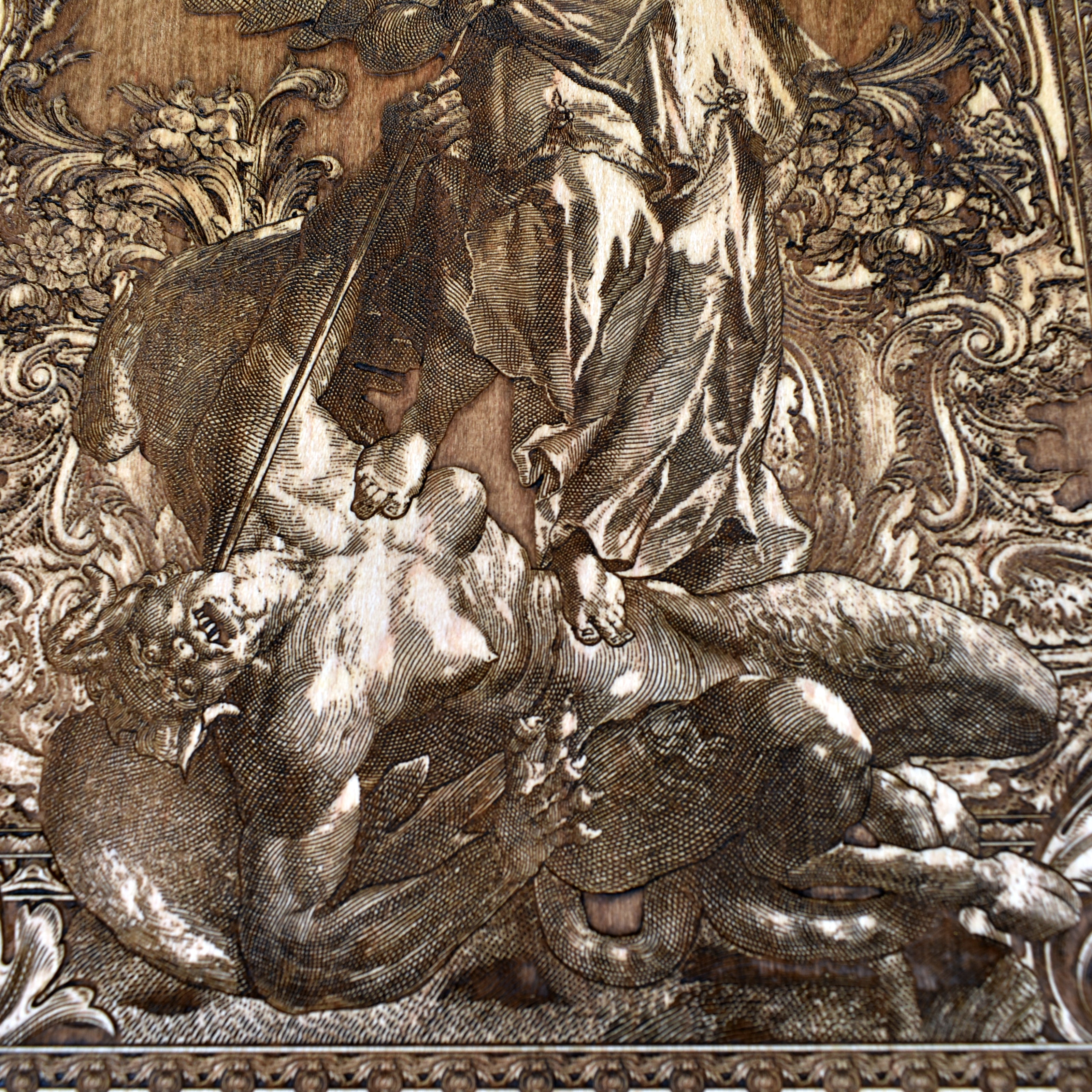 Saint Michael defeating evil engraved on rustic wood wall piece