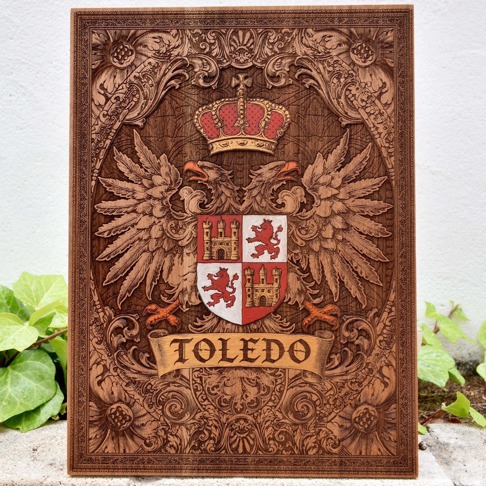 Engraved wooden wall poster featuring the historic coat of arms of Toledo, Spain, with intricate heraldic details carved into natural wood.