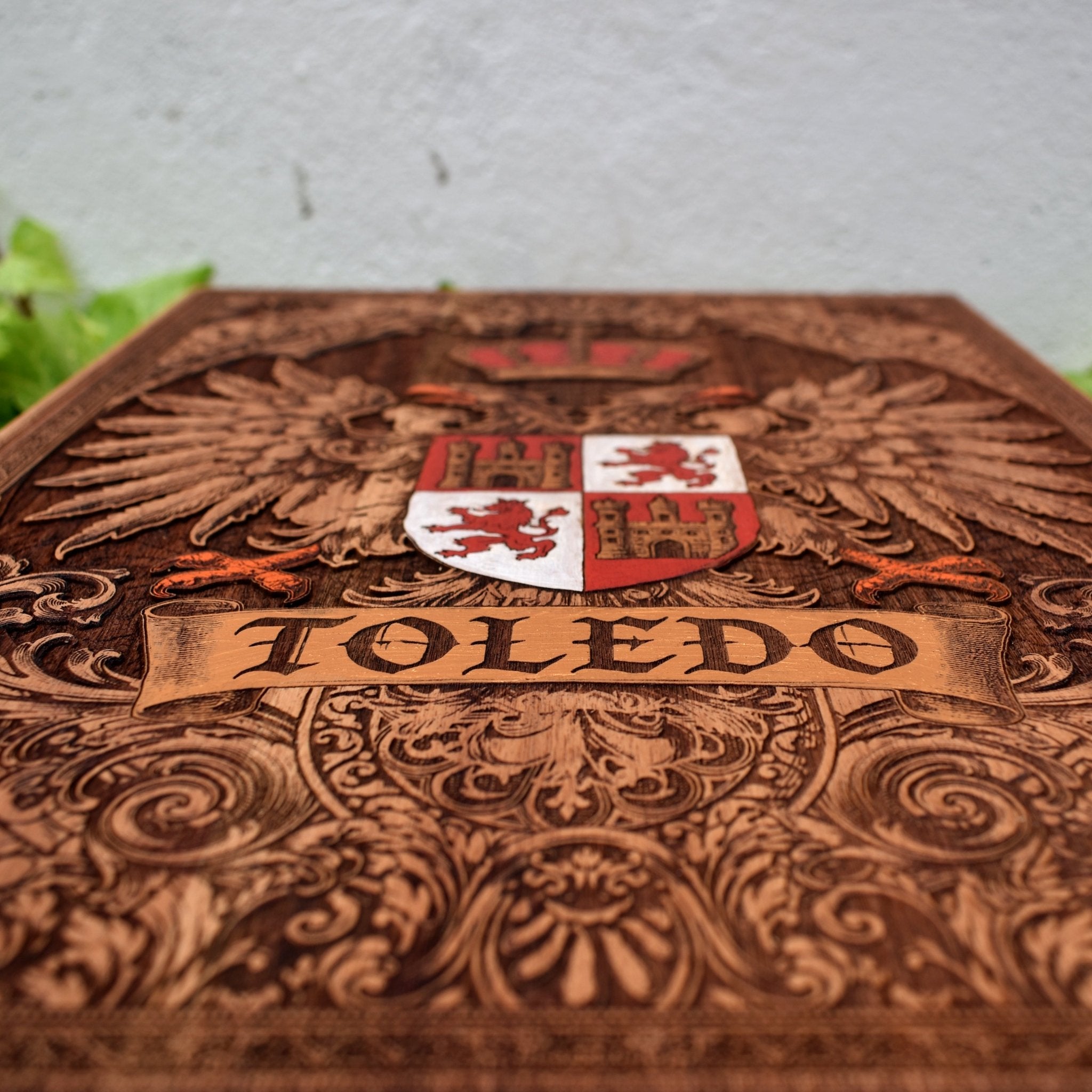 Engraved wooden wall poster featuring the historic coat of arms of Toledo, Spain, with intricate heraldic details carved into natural wood.
