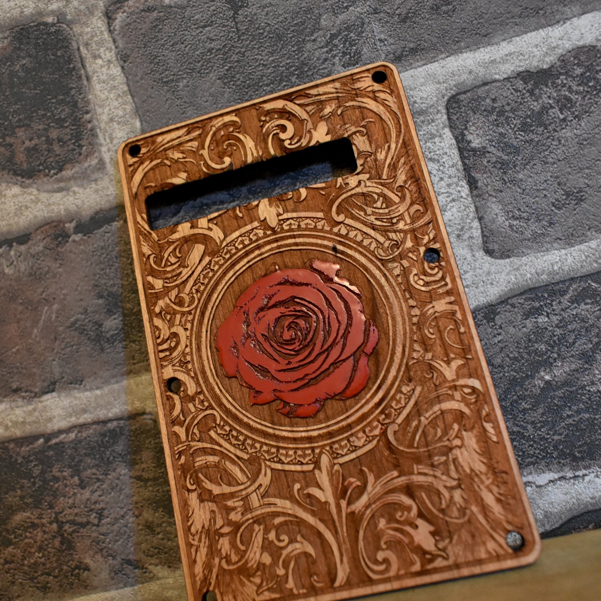 Cherry wood tremolo Stratocaster cover with intricate laser engraving and hand-painted details.