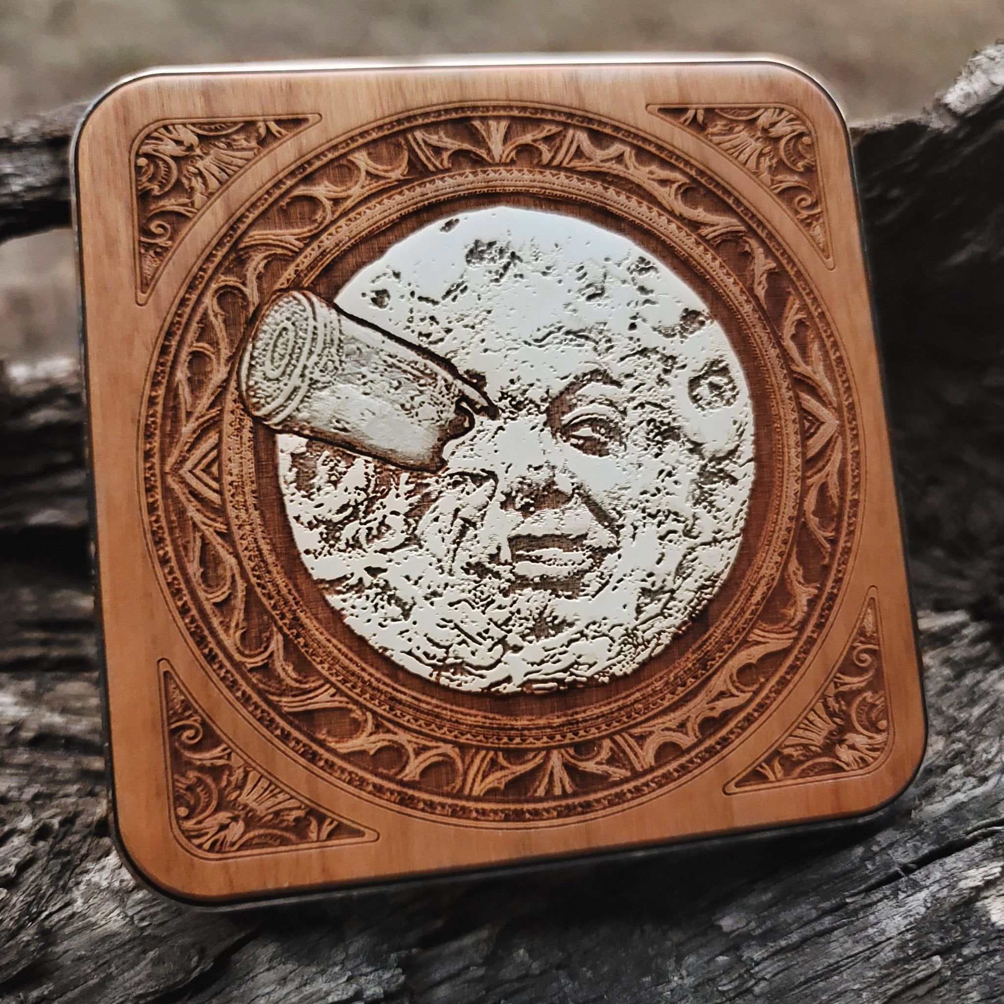Dark wood wireless charger with fantasy moon painting.