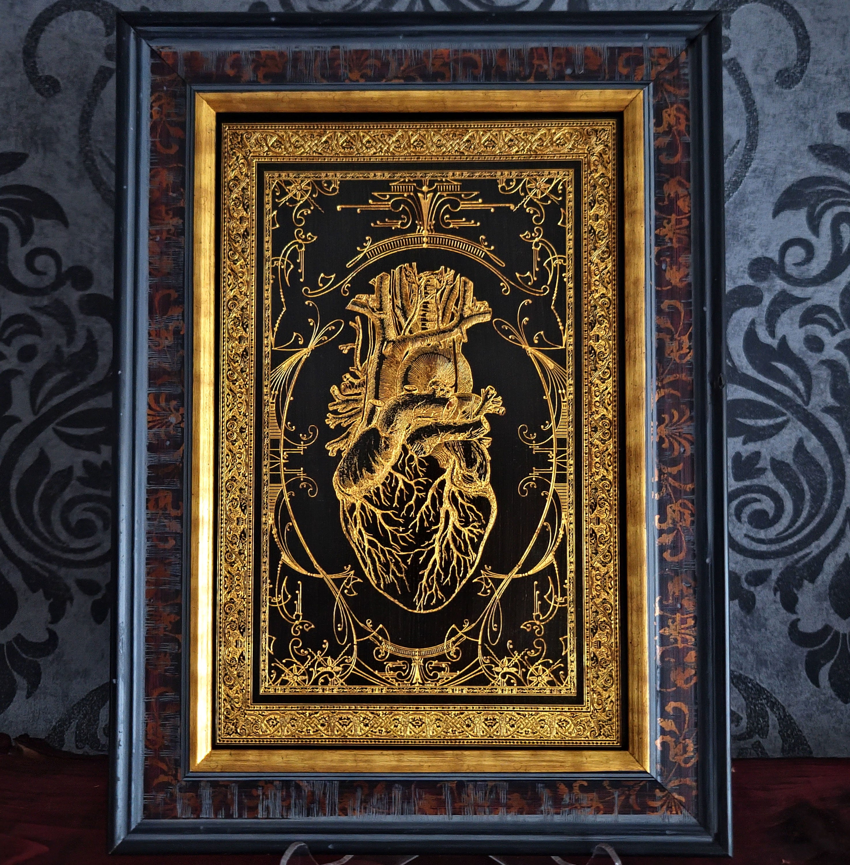 Black anatomical heart wood wall art, engraved for gothic or romantic decor.