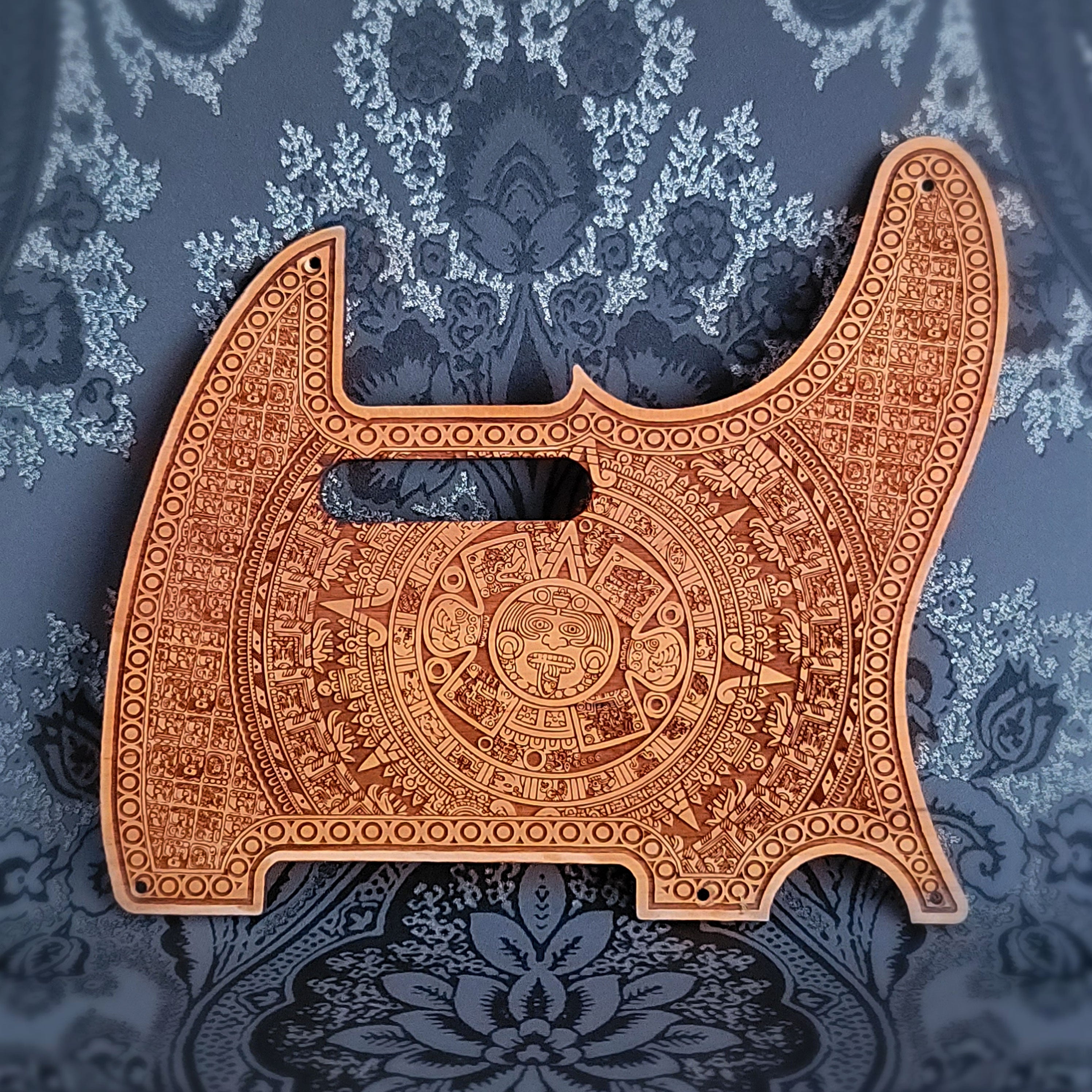 Aztec wood pickguard for Telecaster electric guitar, laser-engraved design.