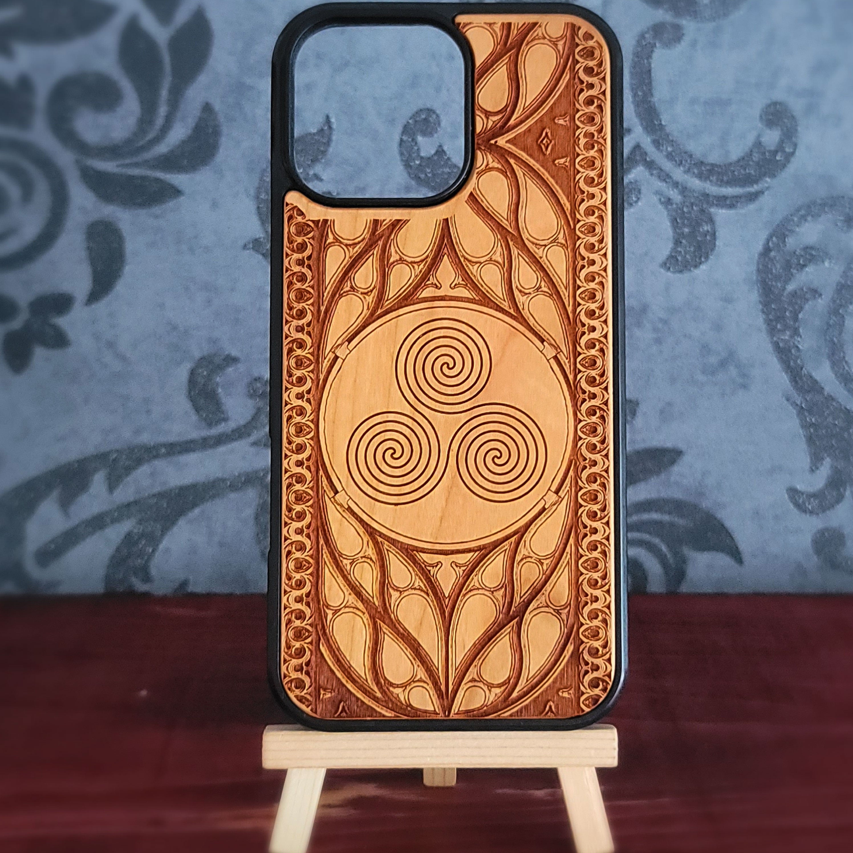 Celtic Spiral engraved wood phone case for iPhone and Galaxy with triskelion symbol in gothic wood frame.