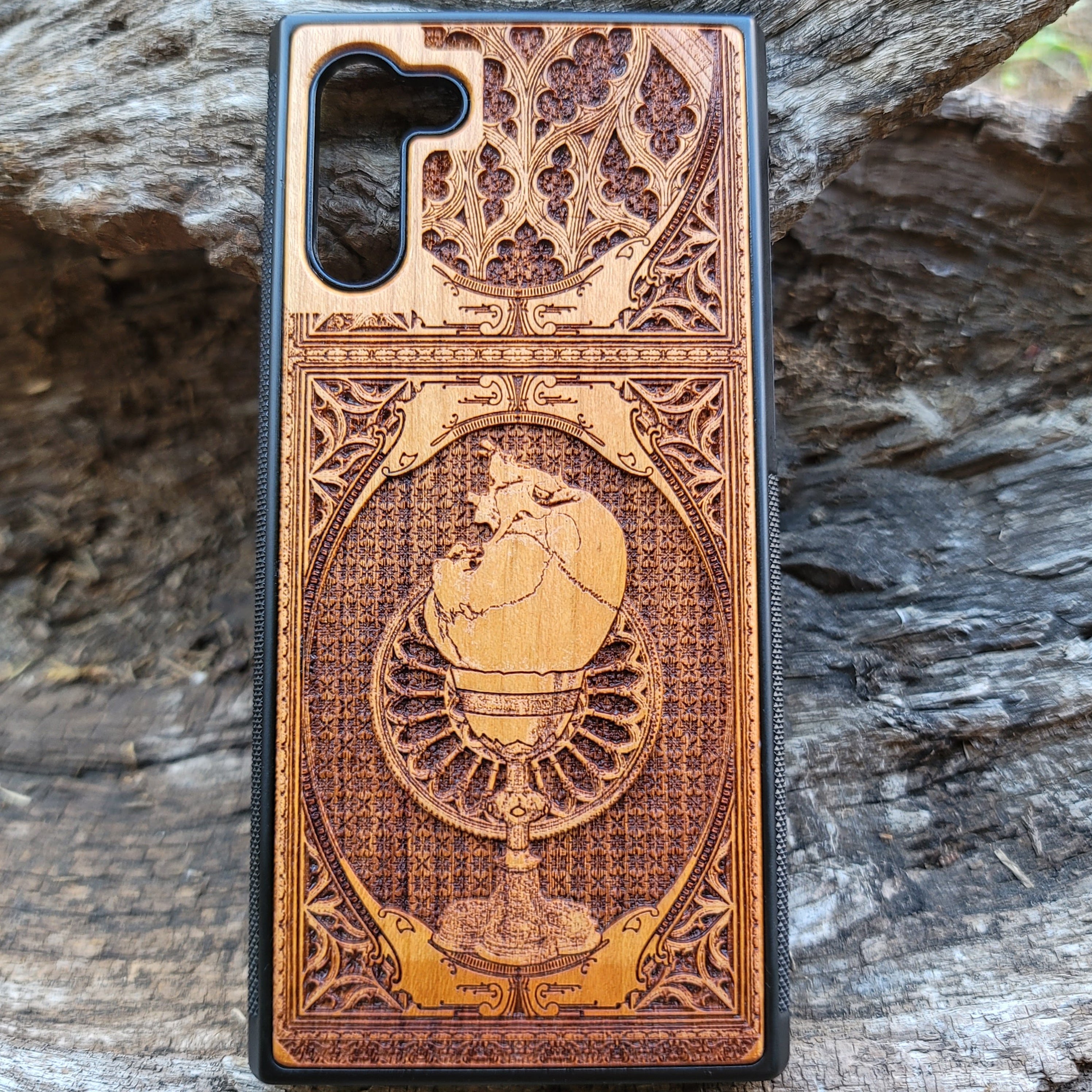 Wooden phone case with a skull inside a chalice design, intricately engraved for iPhone , Samsung Galaxy S, and more. Ideal for gothic and dark fantasy lovers, offering stylish protection for your device