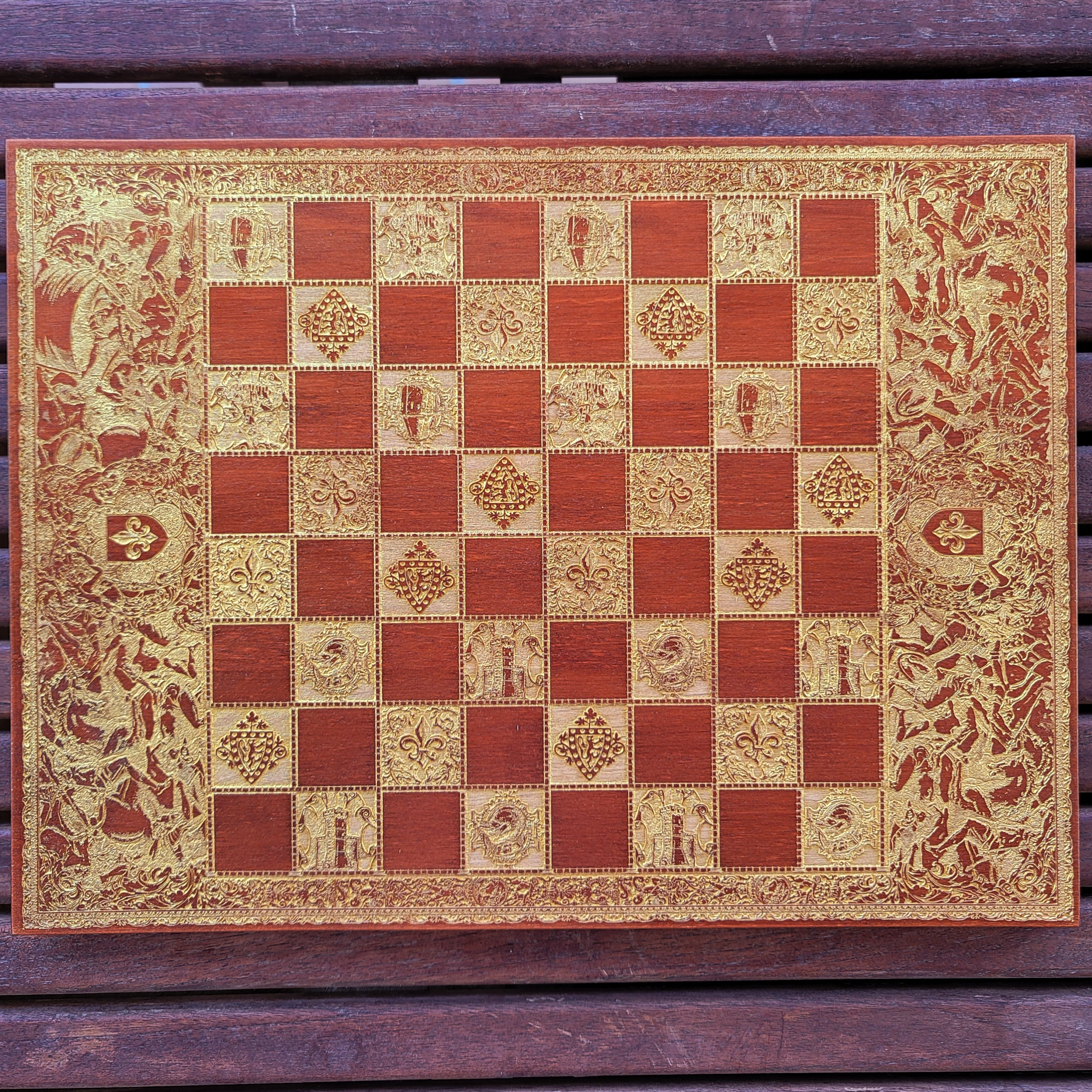Handcrafted wood-stained chessboard with intricate laser-engraved battle design