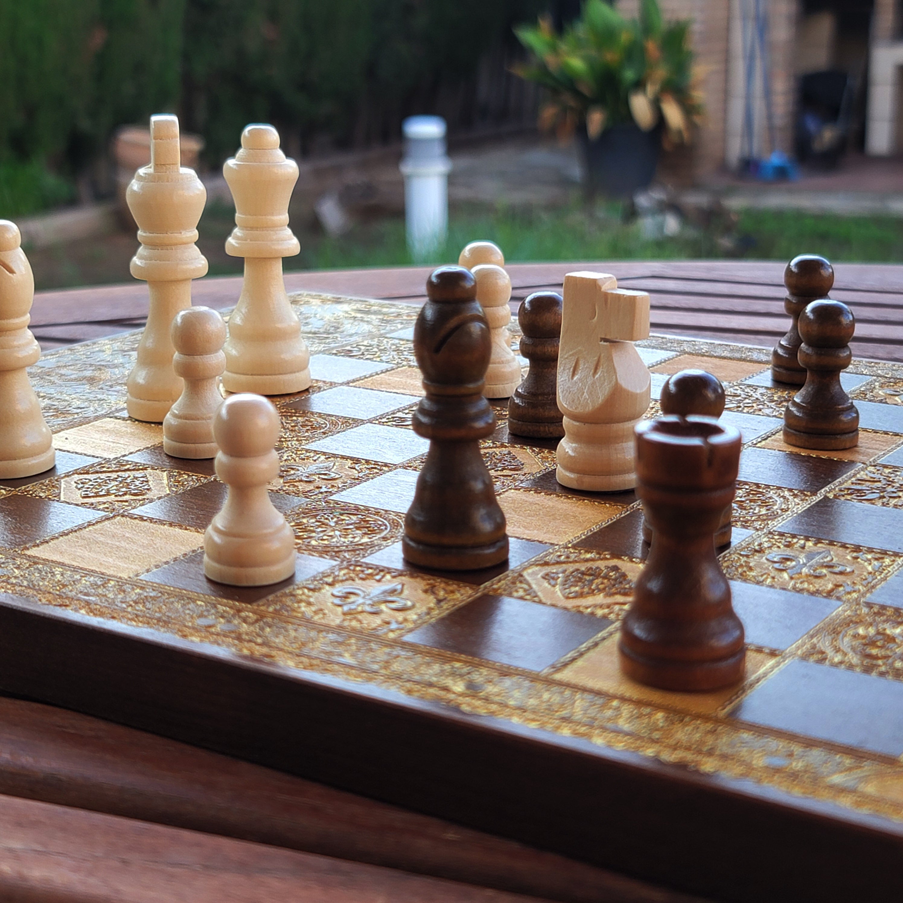 Ornate wood-stained chessboard with handcrafted artistry, ideal for 5-year wedding anniversary or luxury décor.