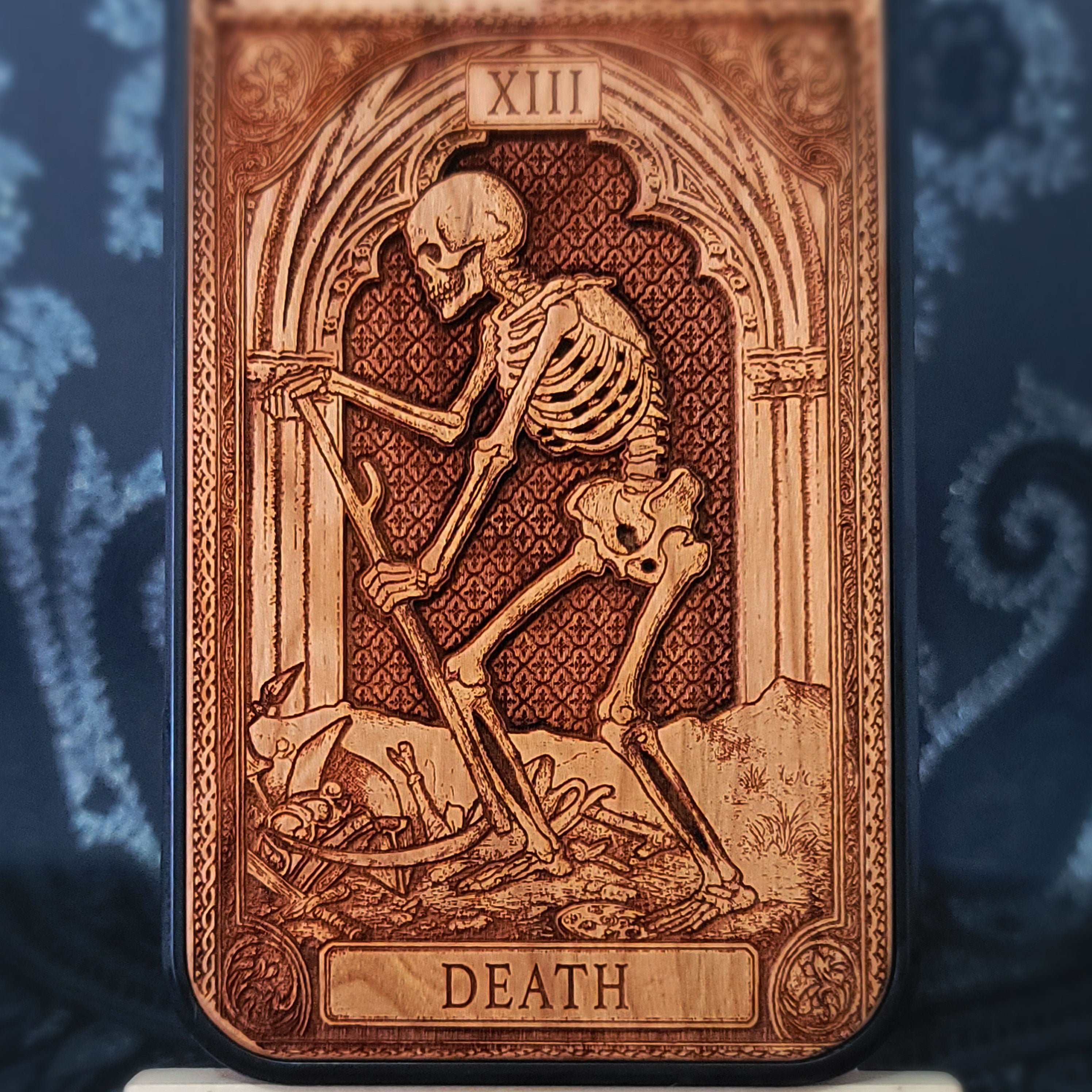 Deep laser engraved wooden phone case featuring the Death tarot card with gothic mystical details on natural wood for iPhone and Samsung Galaxy models.