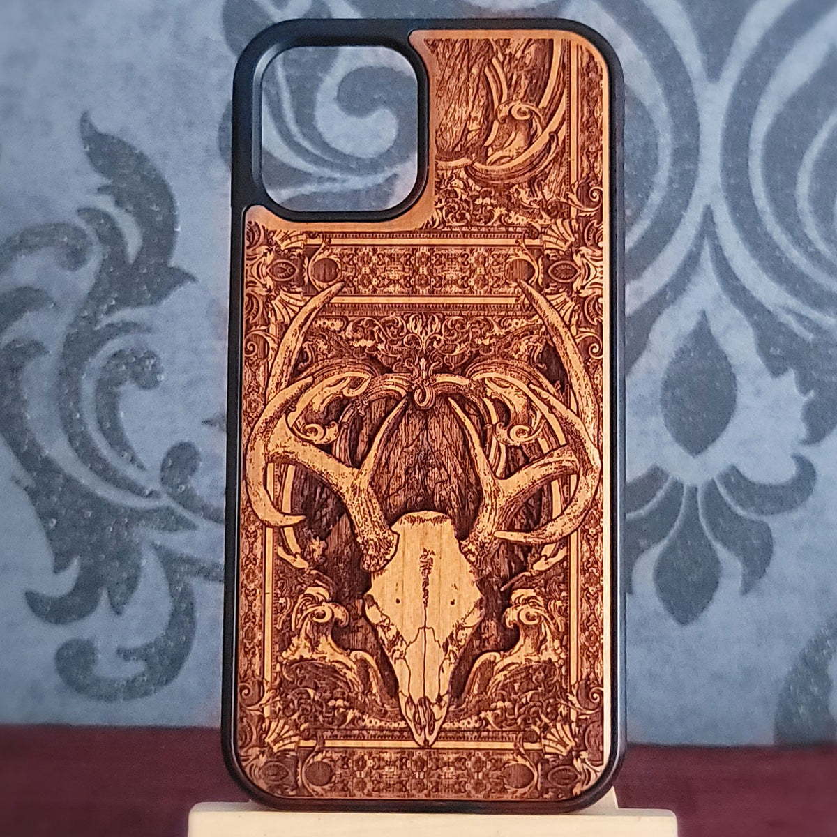 Deer skull engraved wood phone case with detailed antlers and gothic artwork