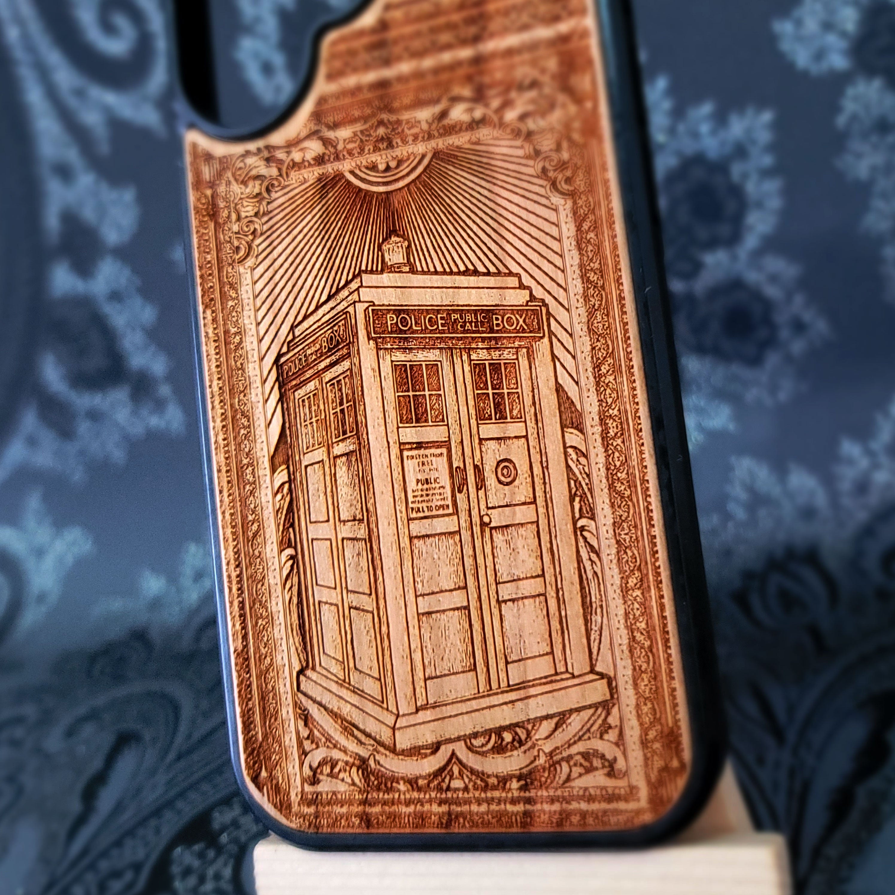 Deep laser engraved wooden phone case featuring a doctor who police box inspired sci-fi design on natural wood for iPhone and Samsung Galaxy models.
