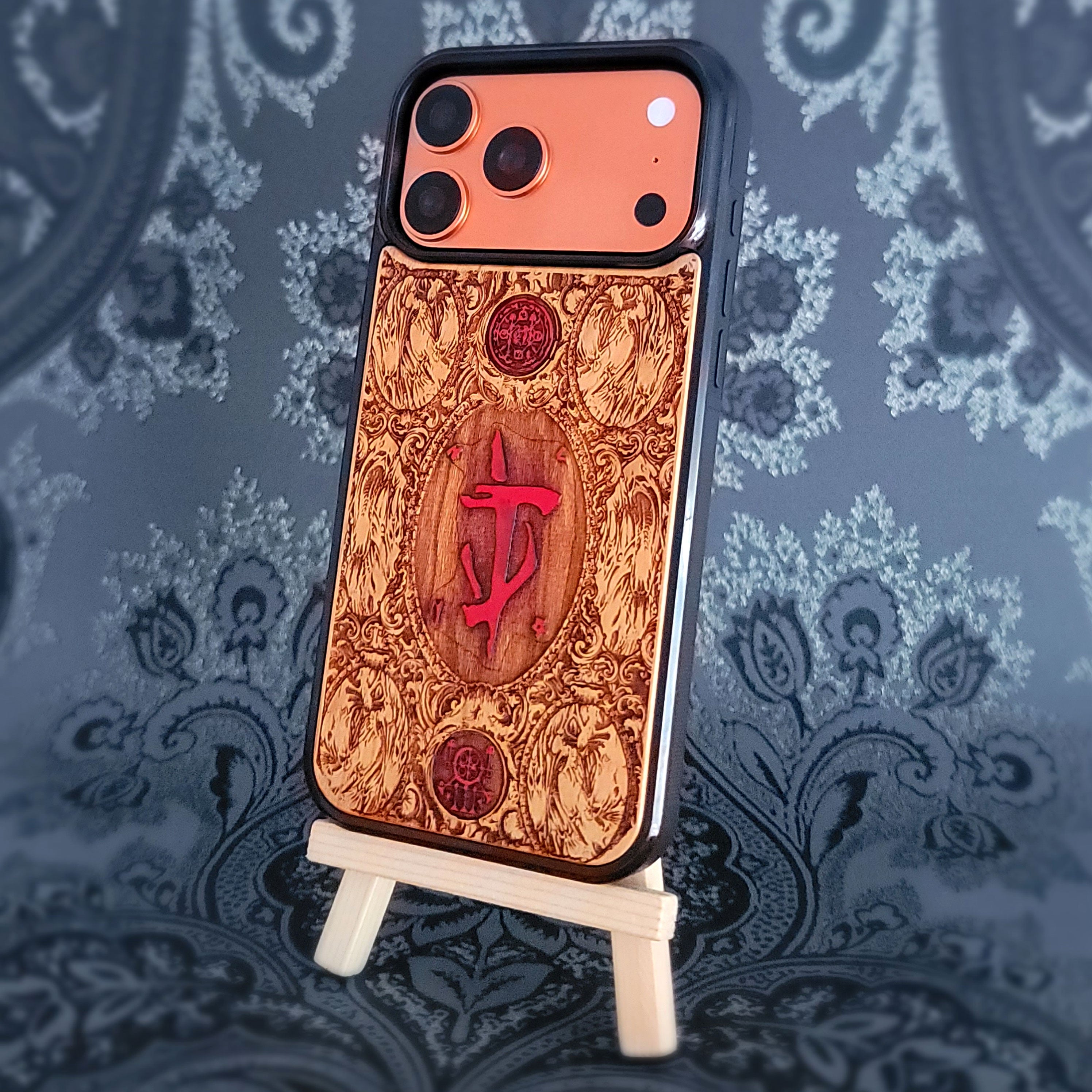 Phone case with intricate design and red doom symbol on a decorative background