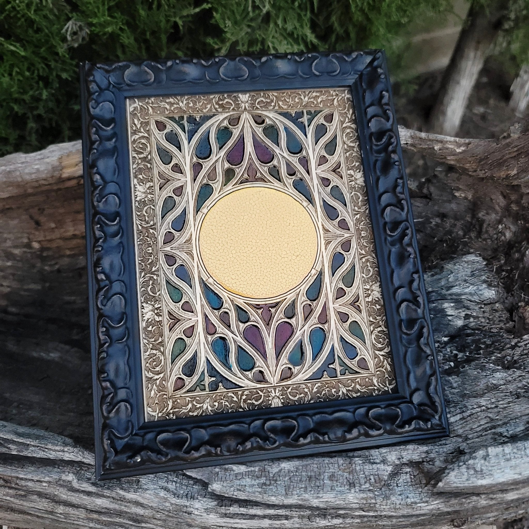 Stained glass-style gothic window engraving on wood with symbolic centerpiece.
