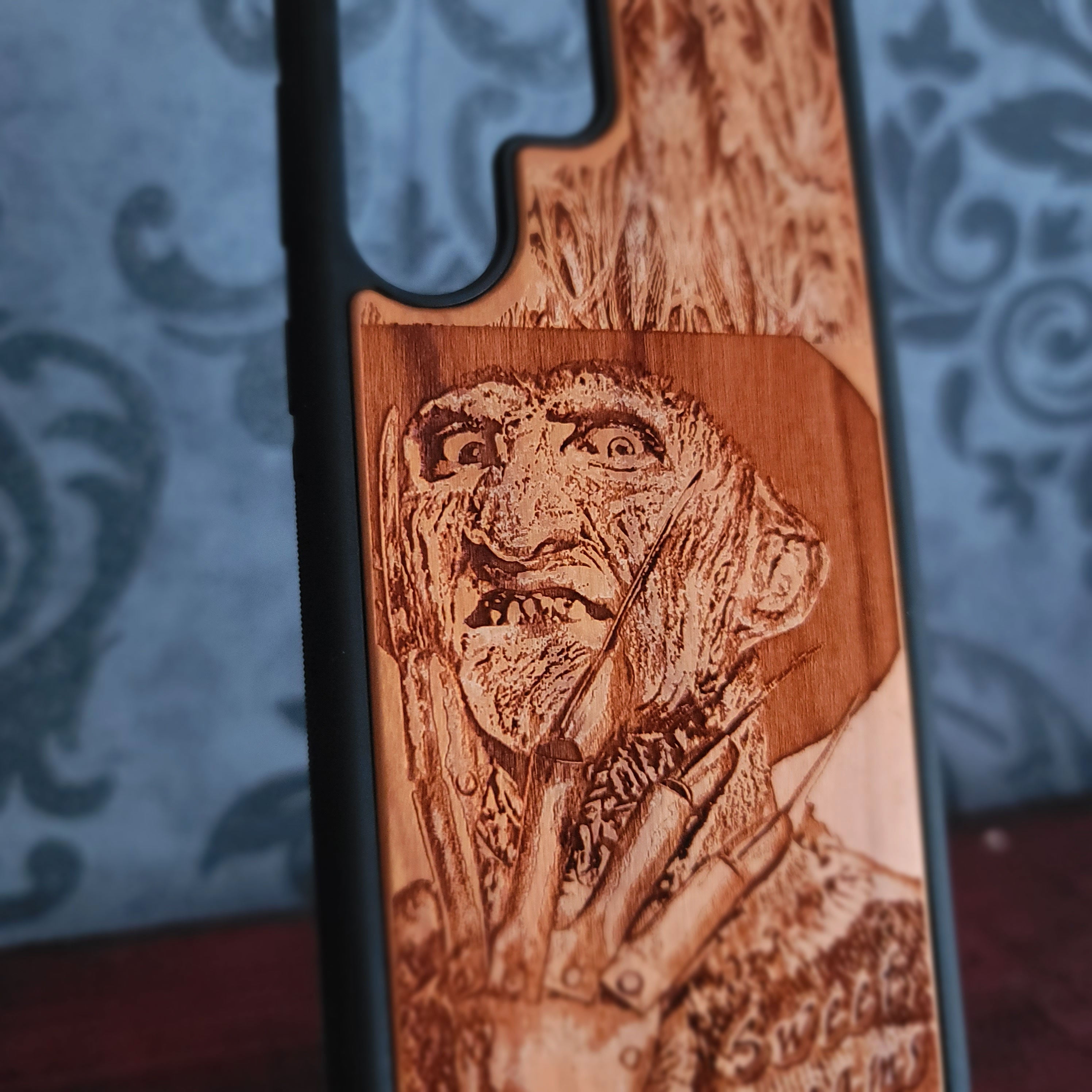 Laser-engraved wooden phone case with Freddy Krueger horror design, perfect for iPhone and Samsung Galaxy