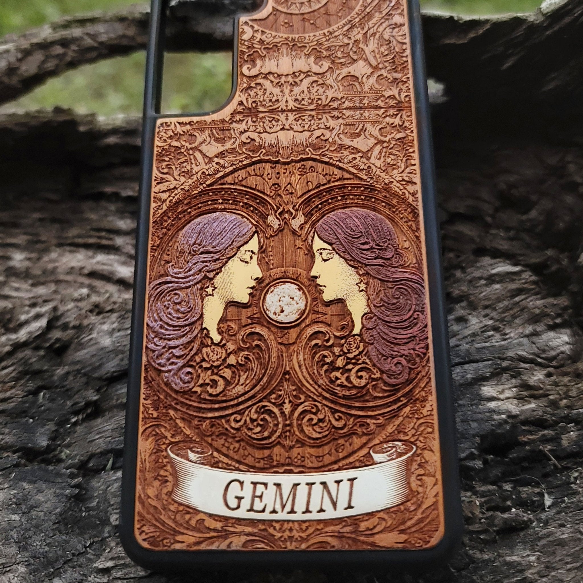 Astrology-themed phone case with engraved Gemini twins