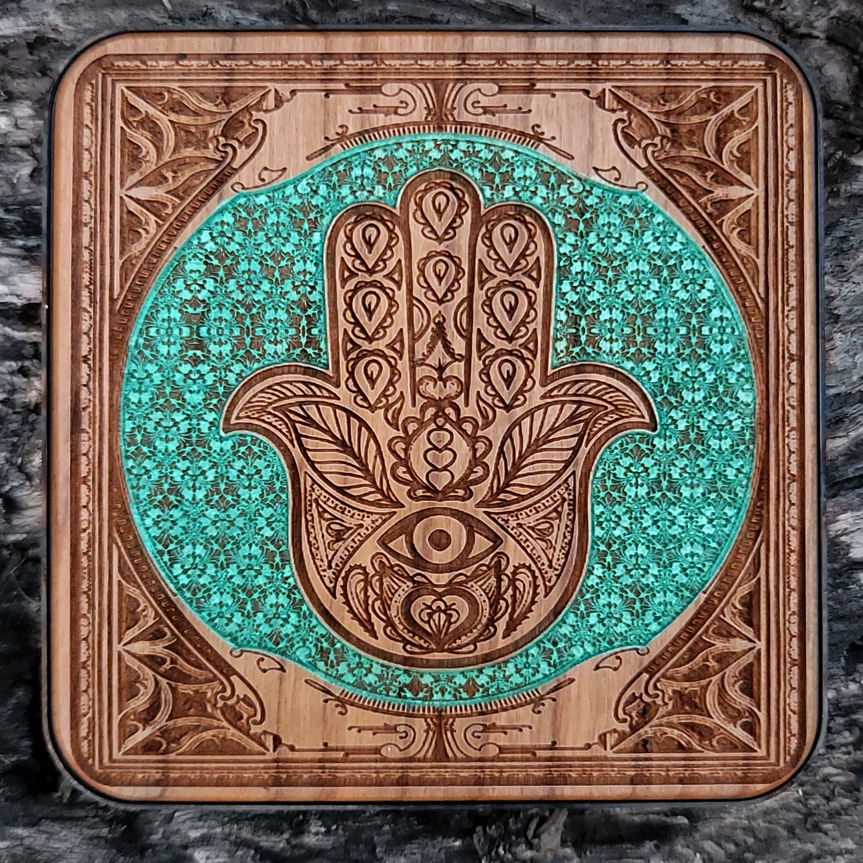 Hand-painted wooden wireless charger featuring Hamsa Hand art.