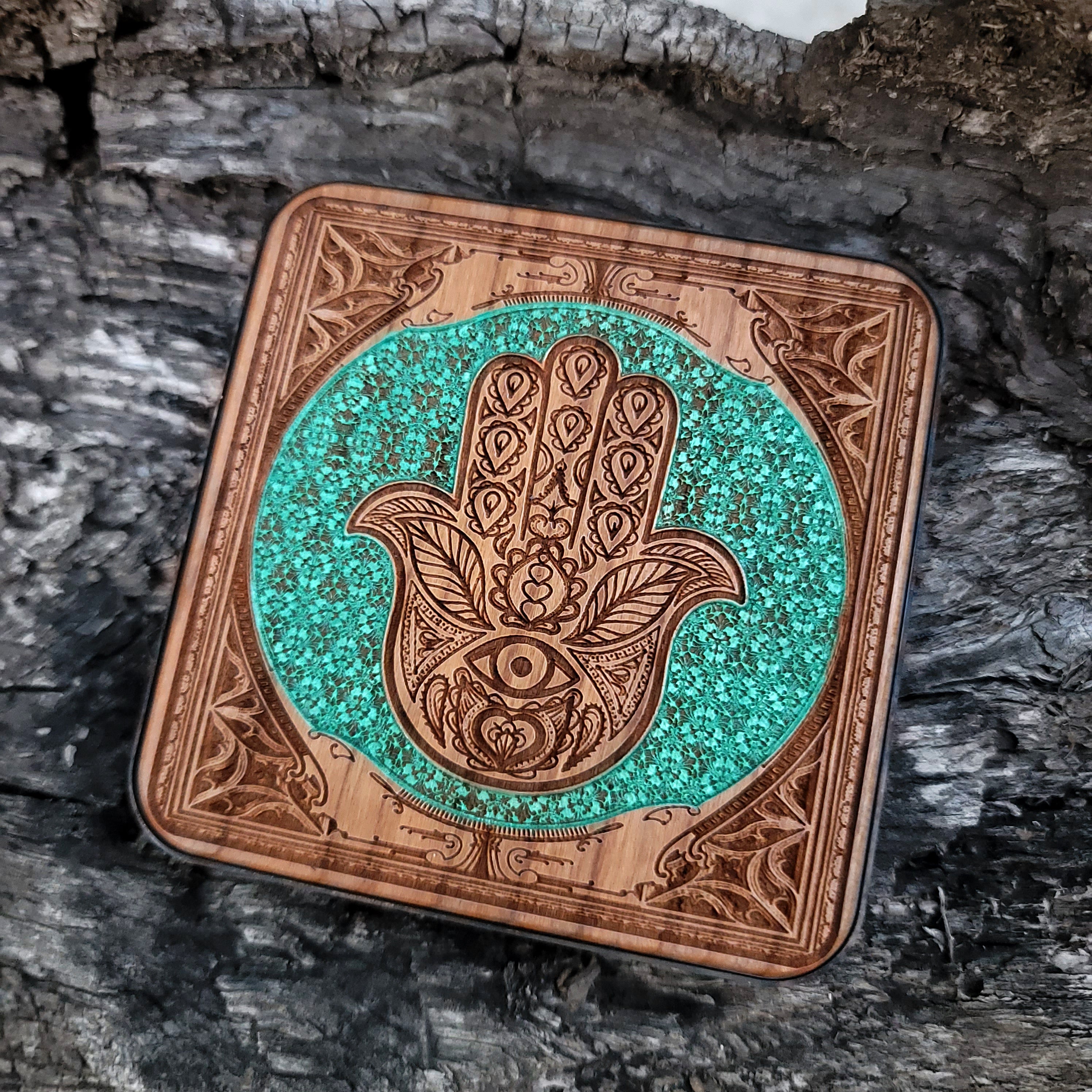 Overhead view of hand-painted protective Hamsa on charger.