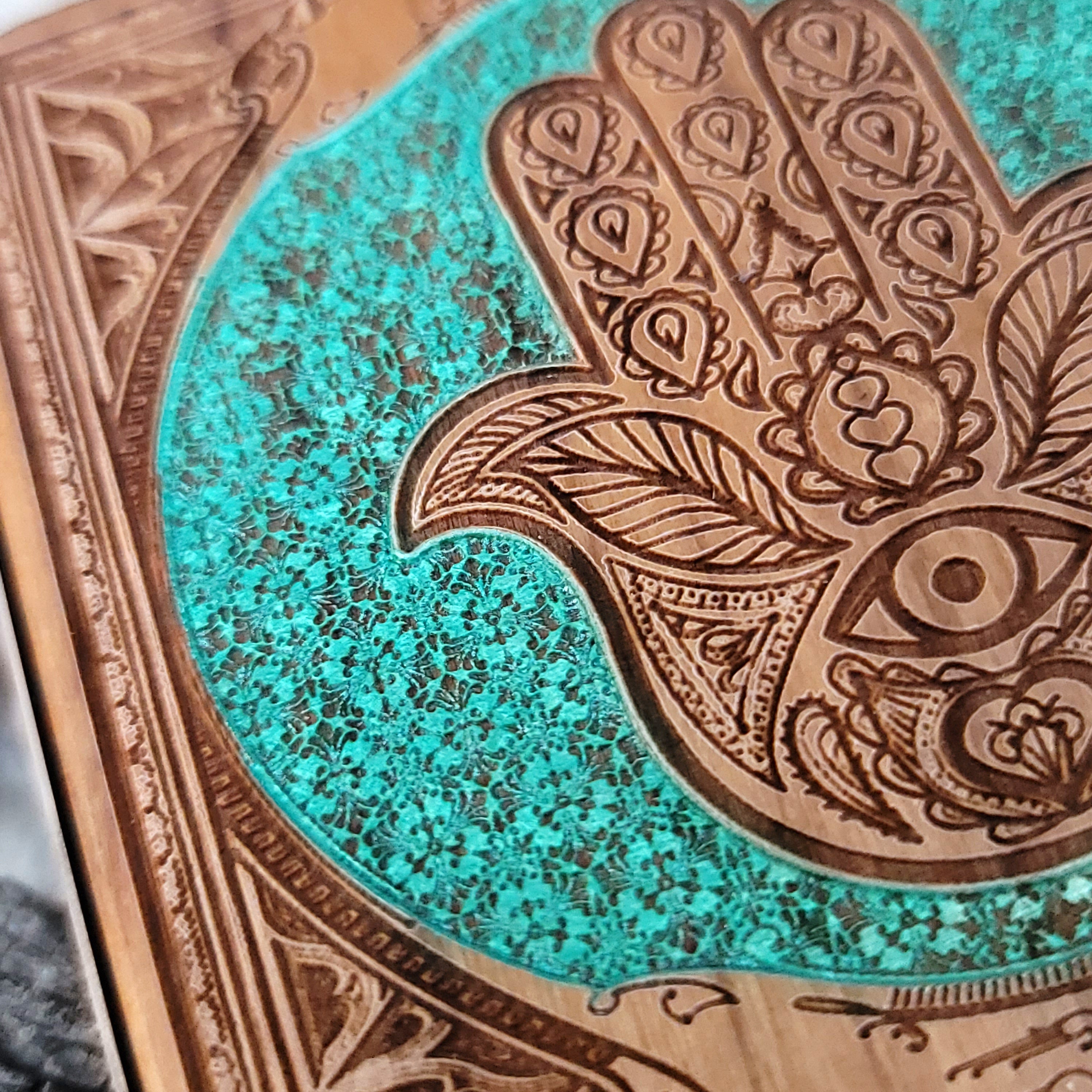 Artisan charger with glowing Hamsa Hand of protection design.