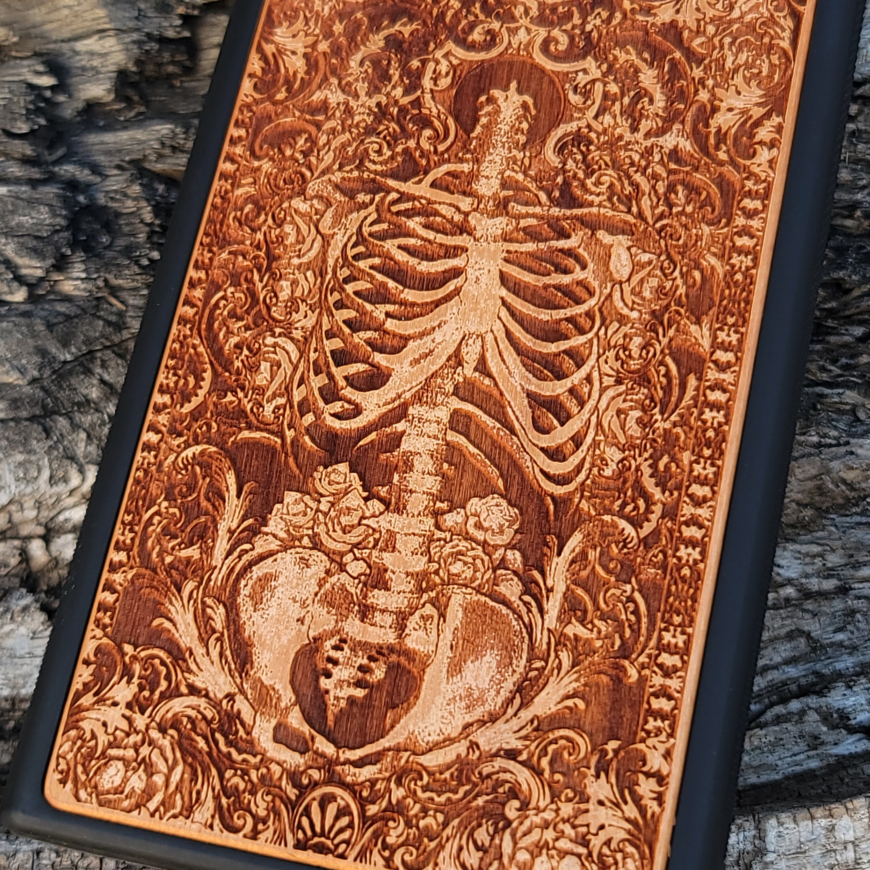 Wooden phone case with a detailed human skeleton torso and roses design, engraved for iPhone , iPhone 15, Galaxy S23 Ultra, Note 20, and more. Perfect for gothic art lovers seeking a unique phone accessory.
