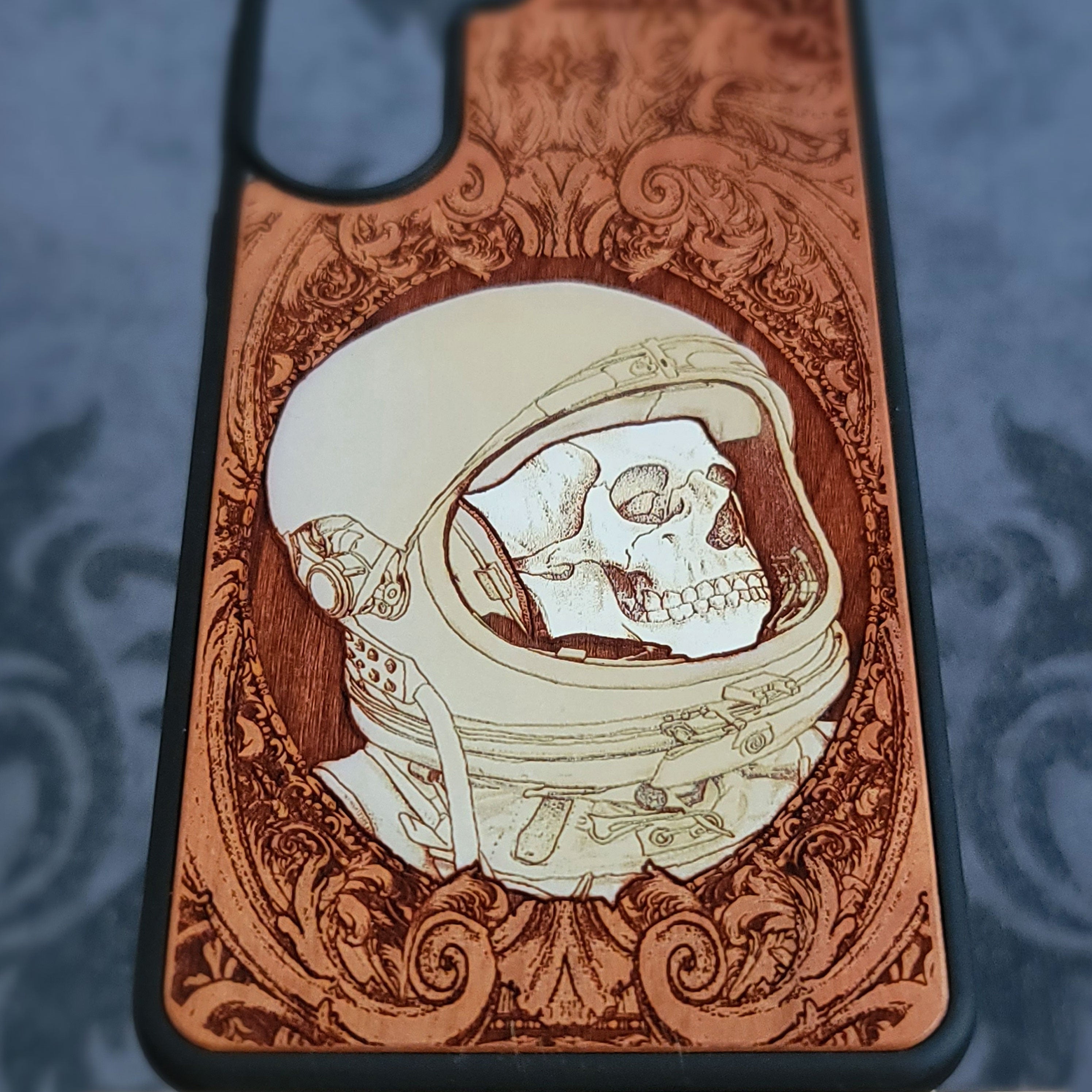 Hand-painted gothic wood phone case with astronaut skull design, compatible with iPhone and Galaxy, featuring space horror art.
