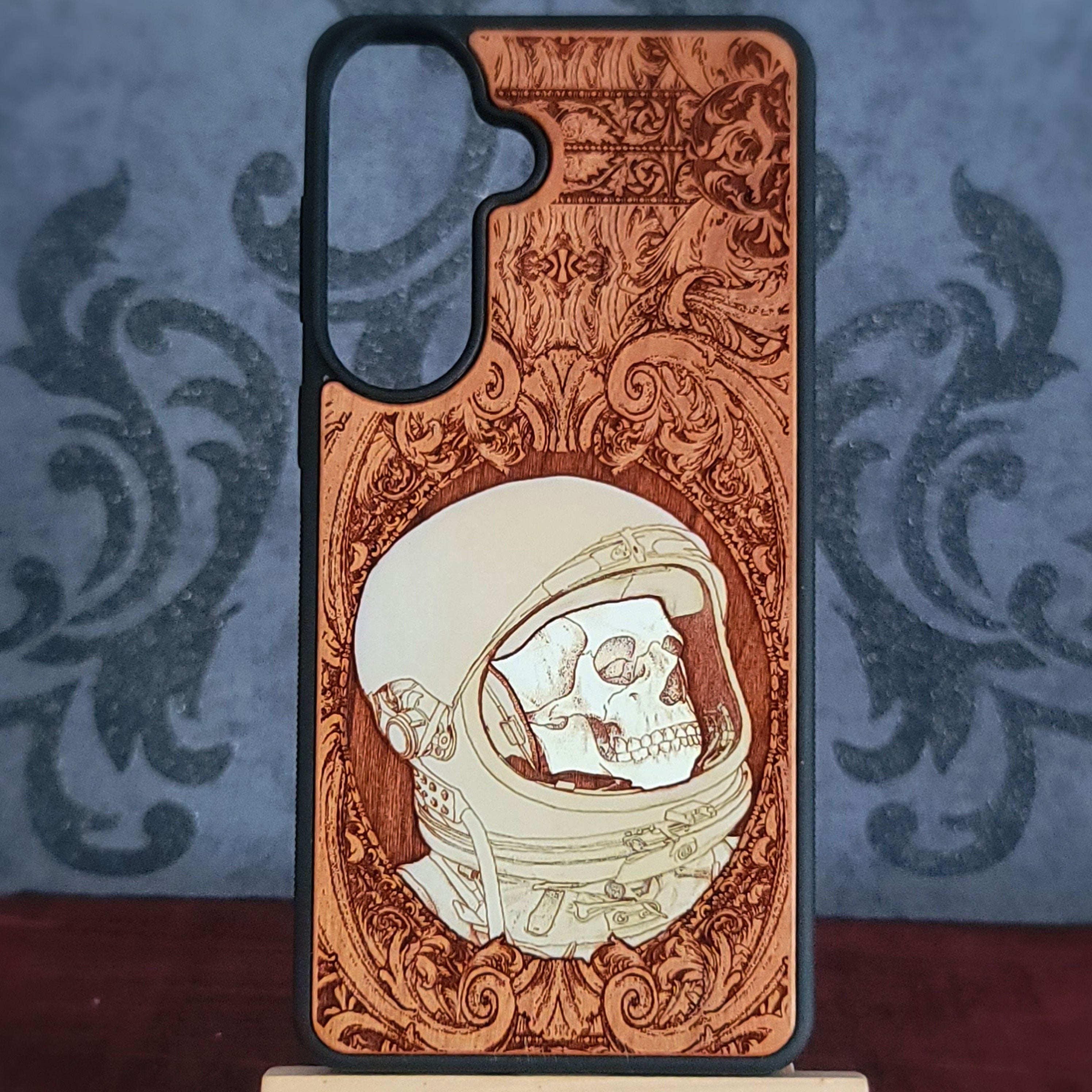 Hand-painted gothic wood phone case with astronaut skull design, compatible with iPhone and Galaxy, featuring space horror art.